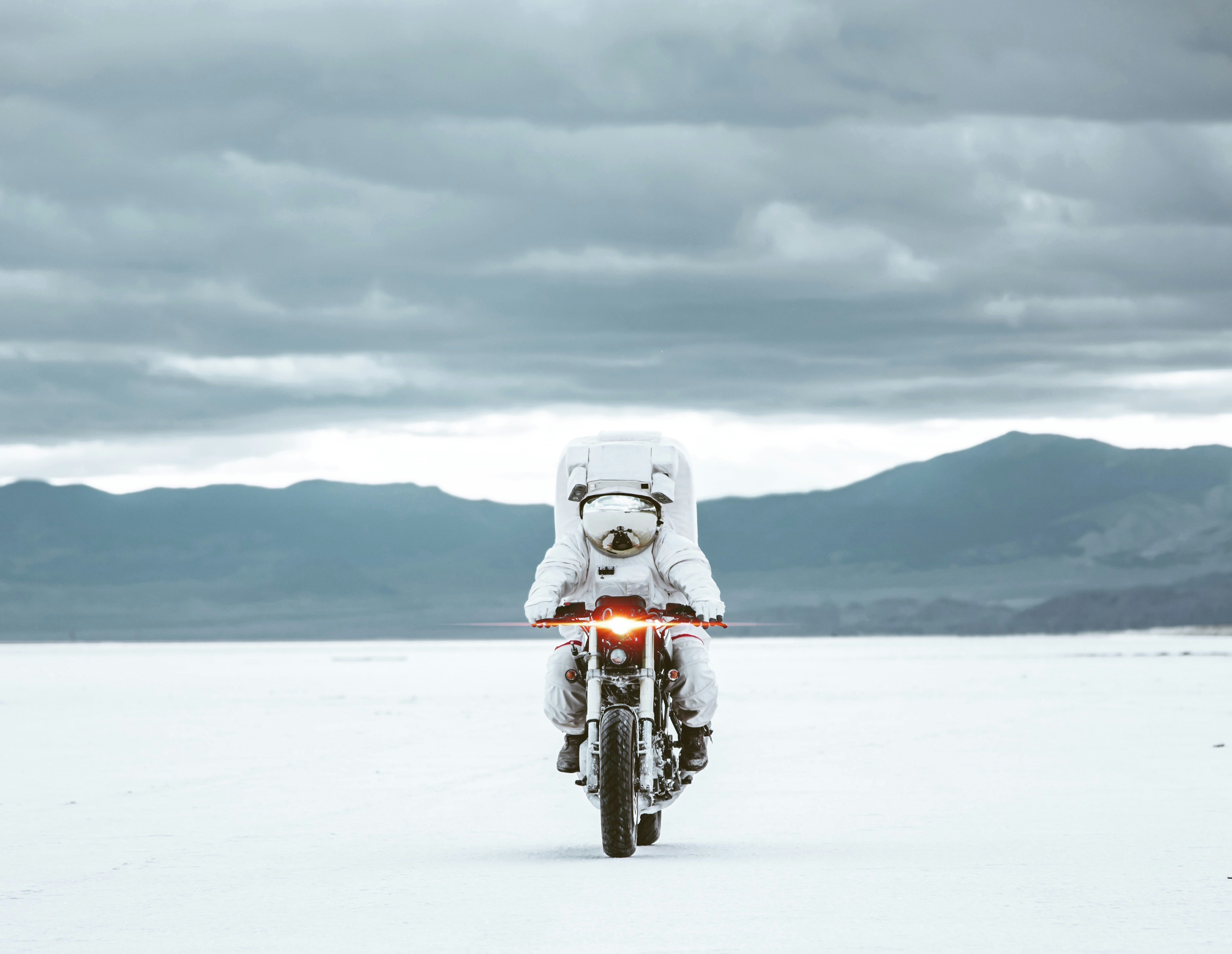 Astronaut Riding Motorcycle on Salt Flat