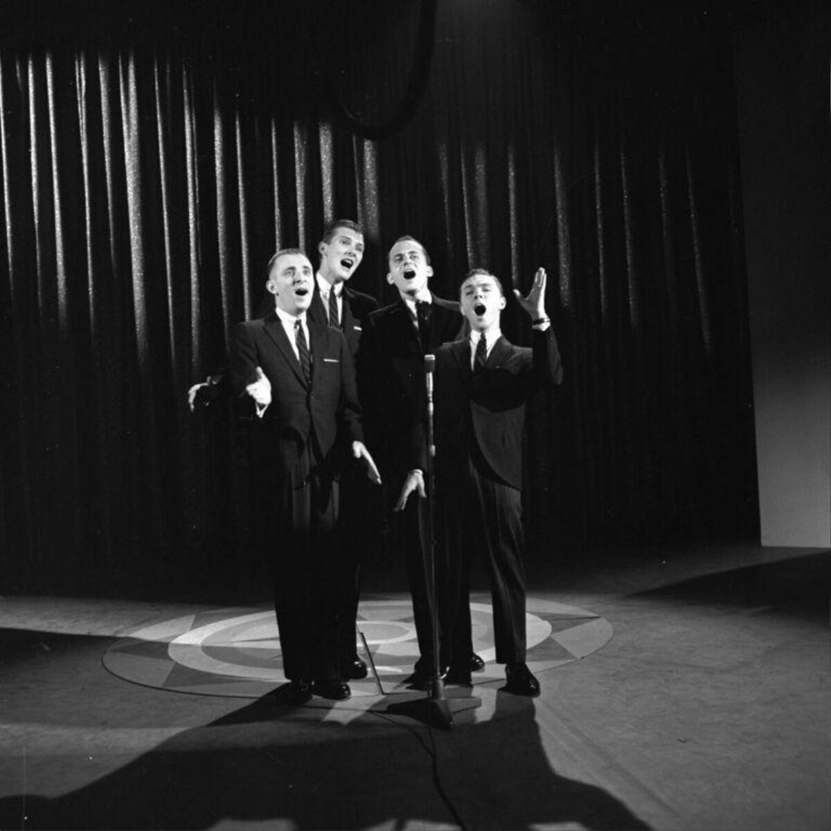 Four Male Singers Performing on Stage