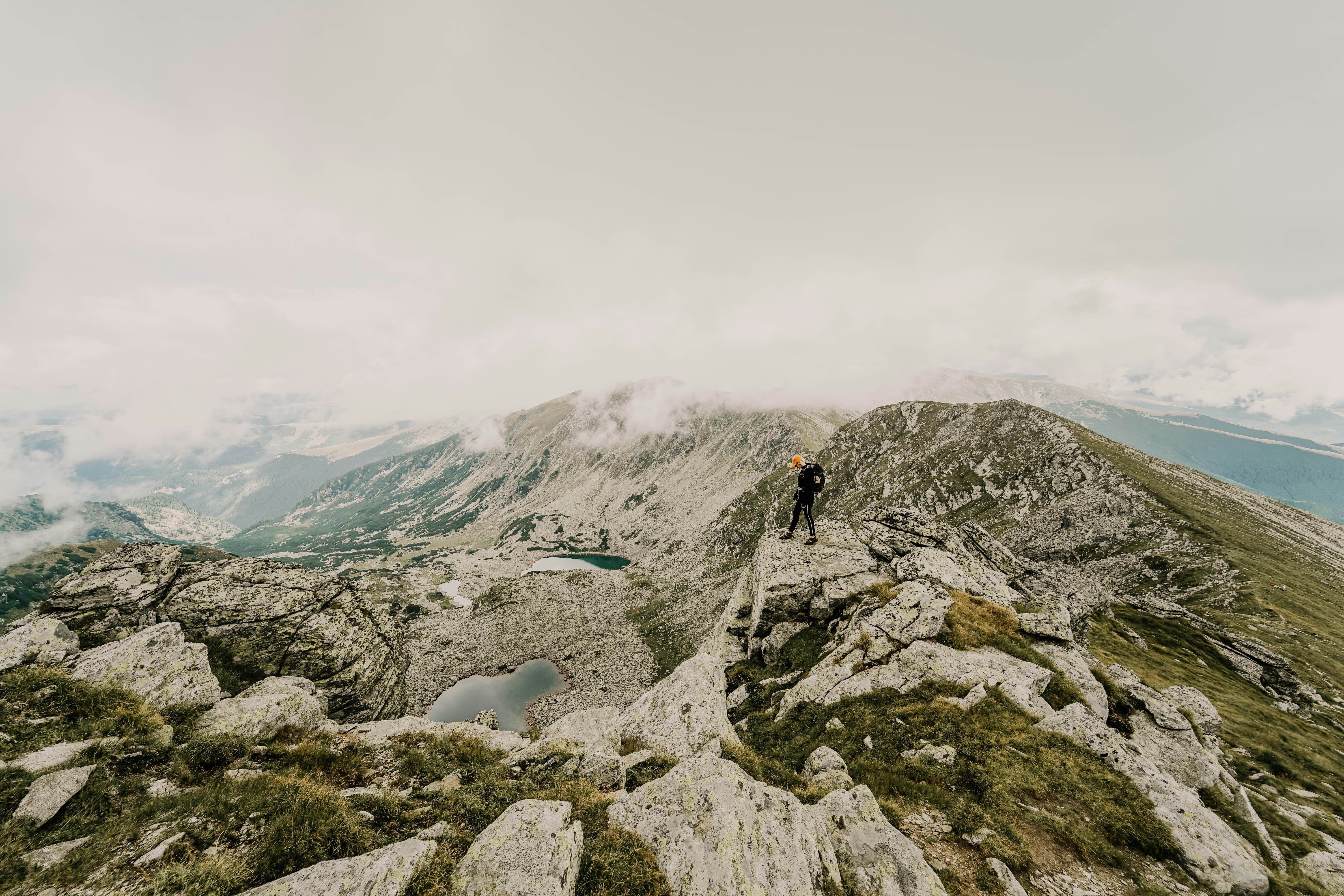 Hiker Standing on Mountain Ridge