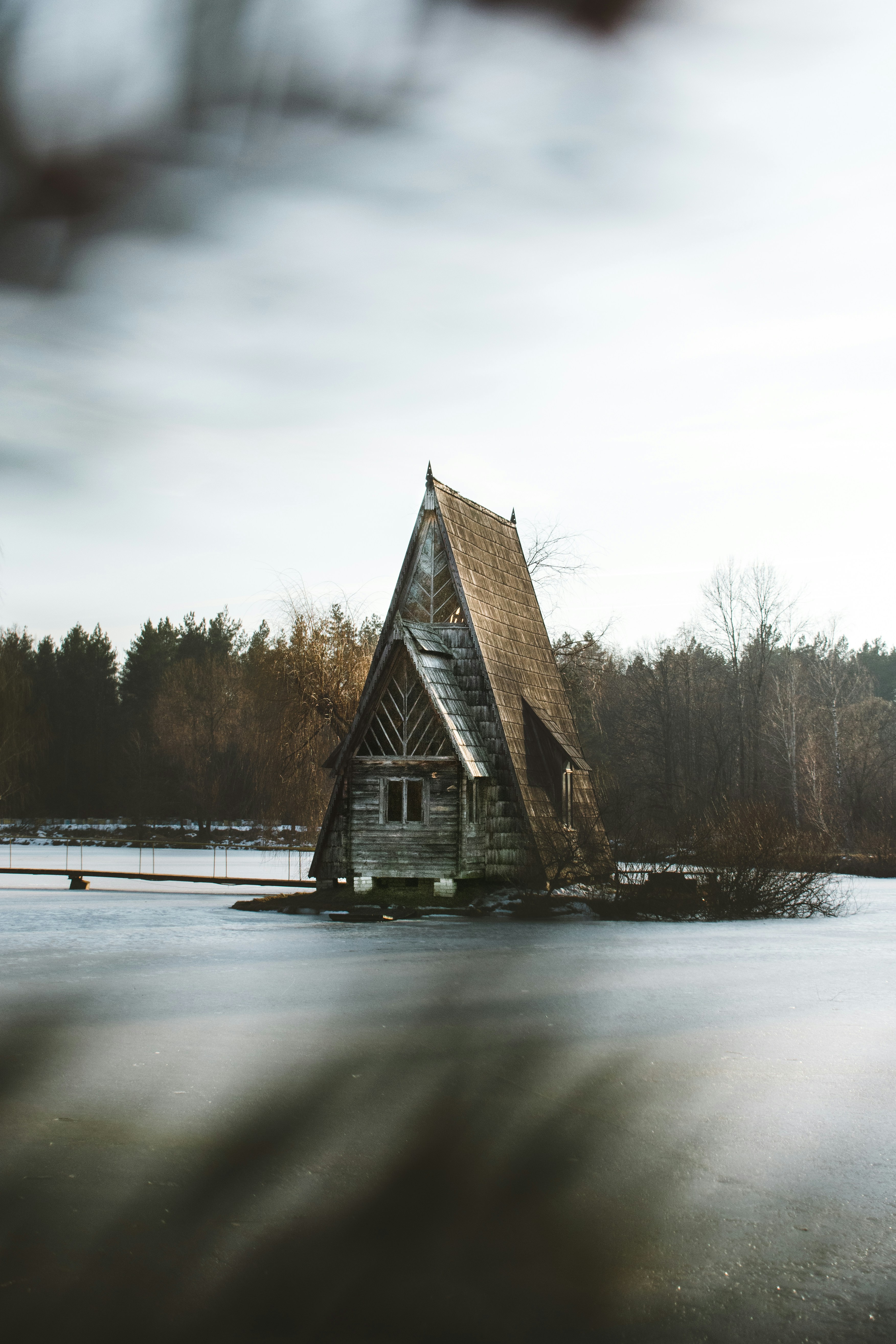 A-frame Wooden House on Frozen Lake