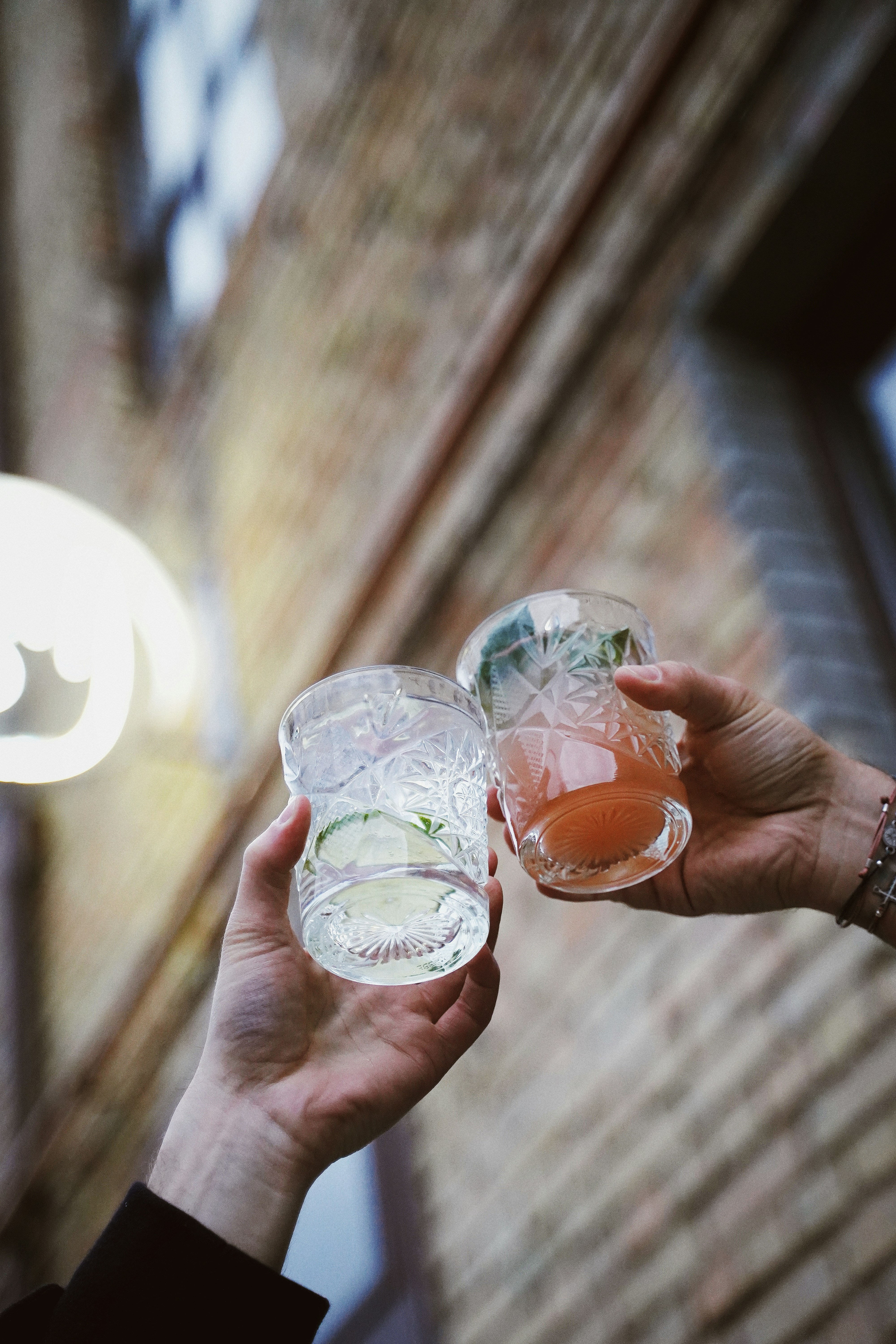 Two People Toasting With Drinks