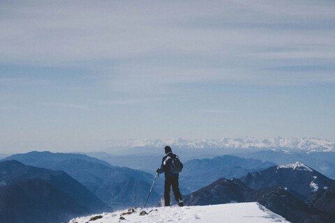 Hiker on Snowy Mountain Peak