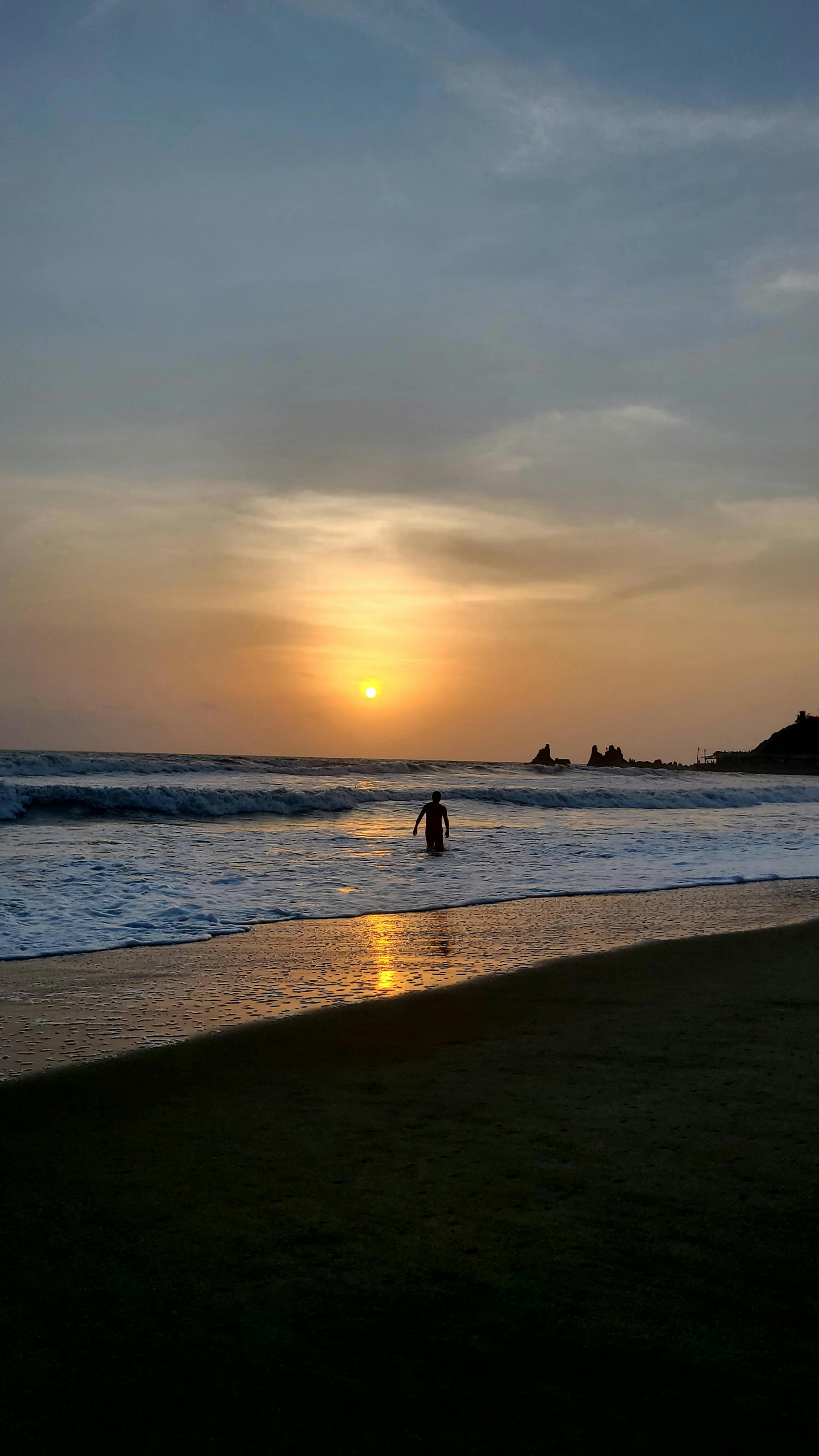 Sunset Beach with Lone Swimmer