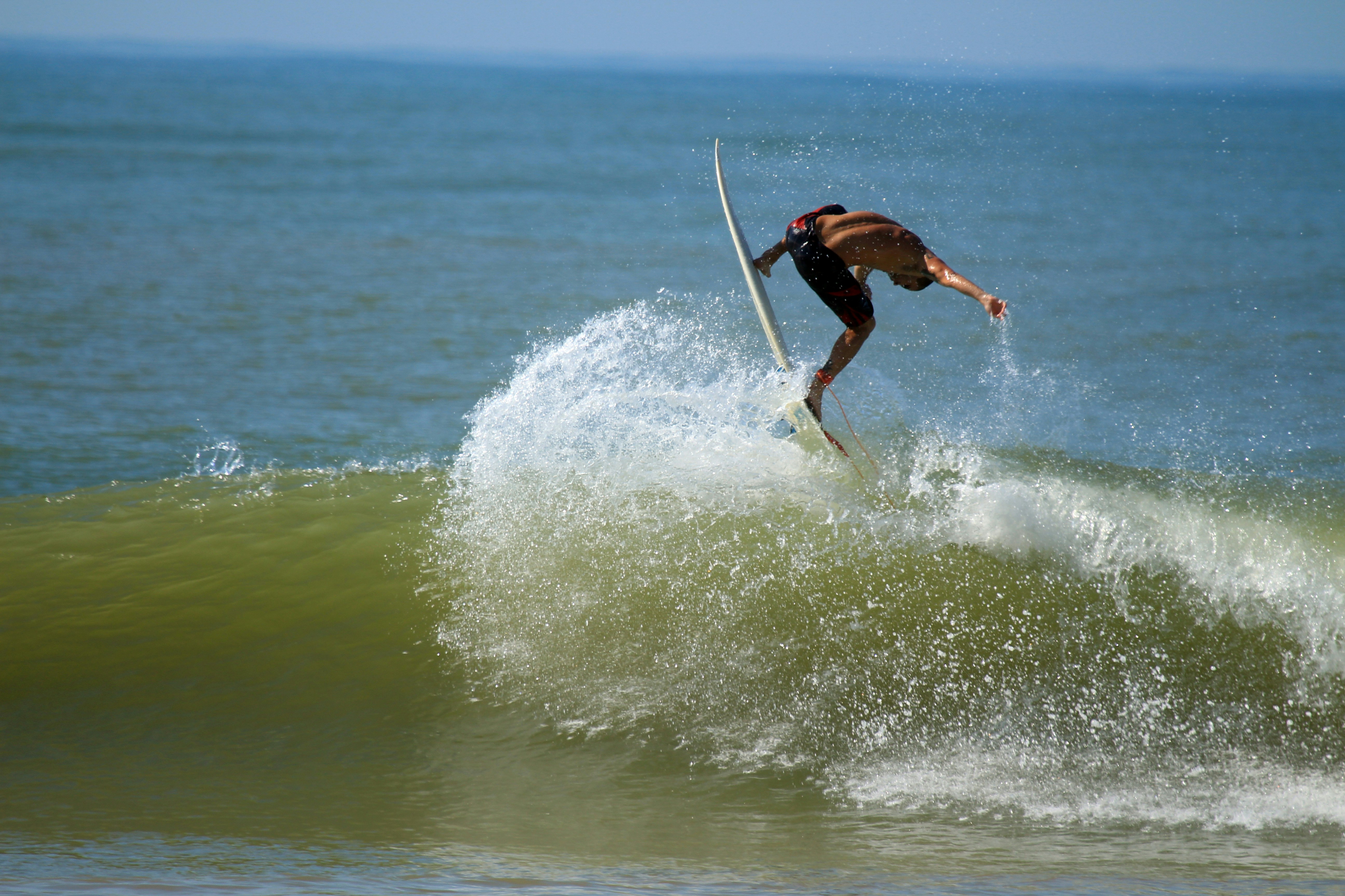 Surfer Performing Maneuver on Ocean Wave