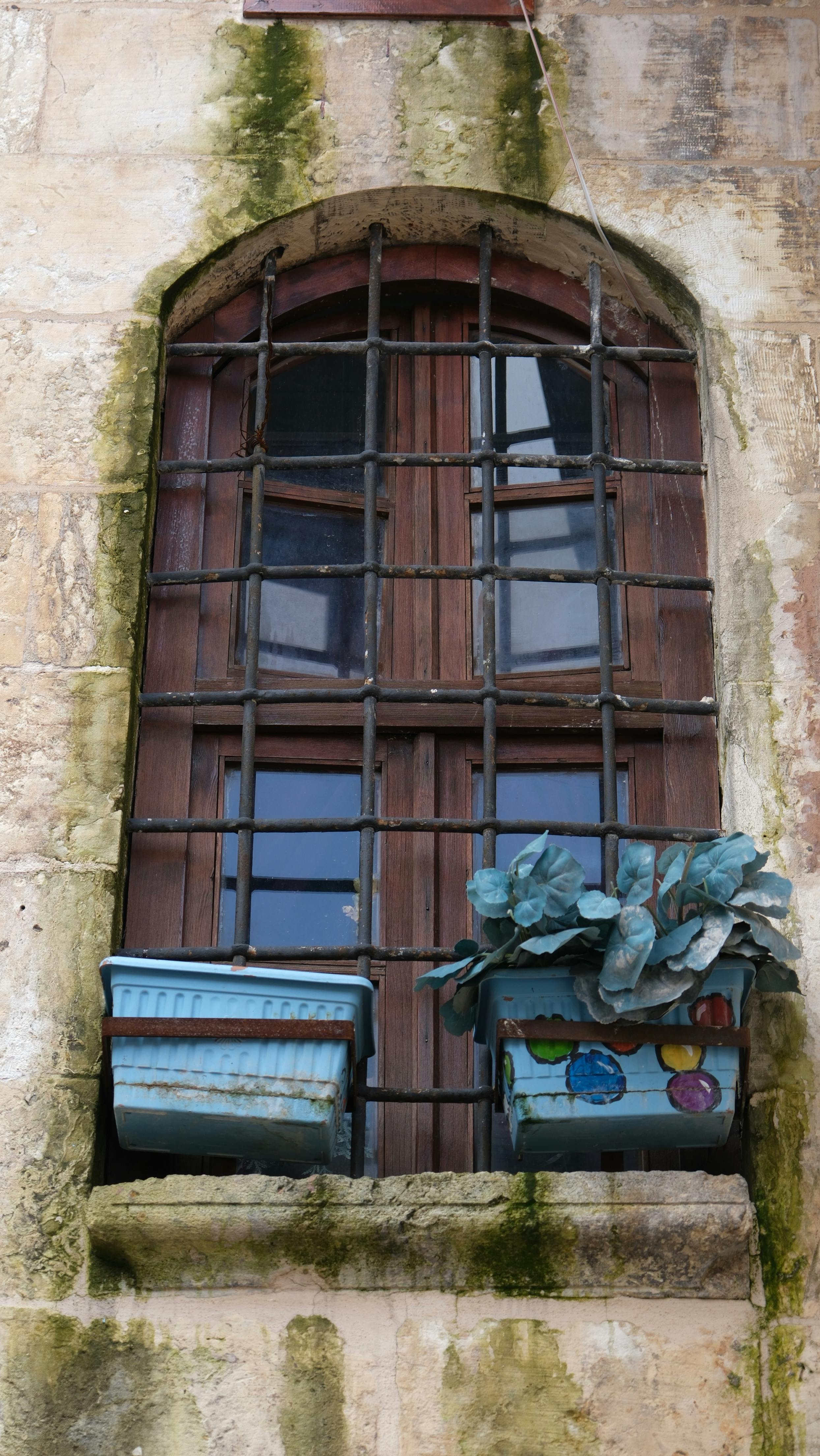 Old Arched Window with Iron Grille