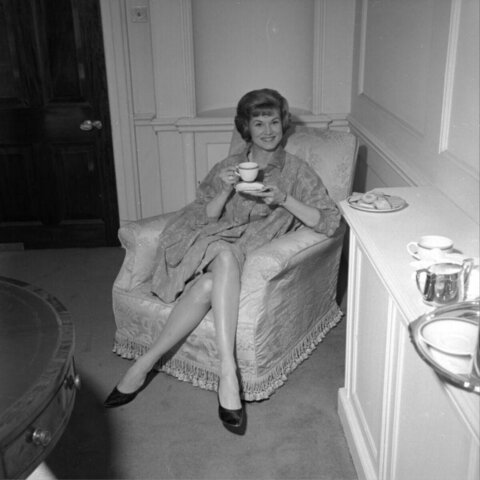 Woman Enjoying Tea in Armchair