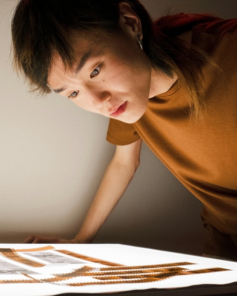 Photographer Examining Film Negatives