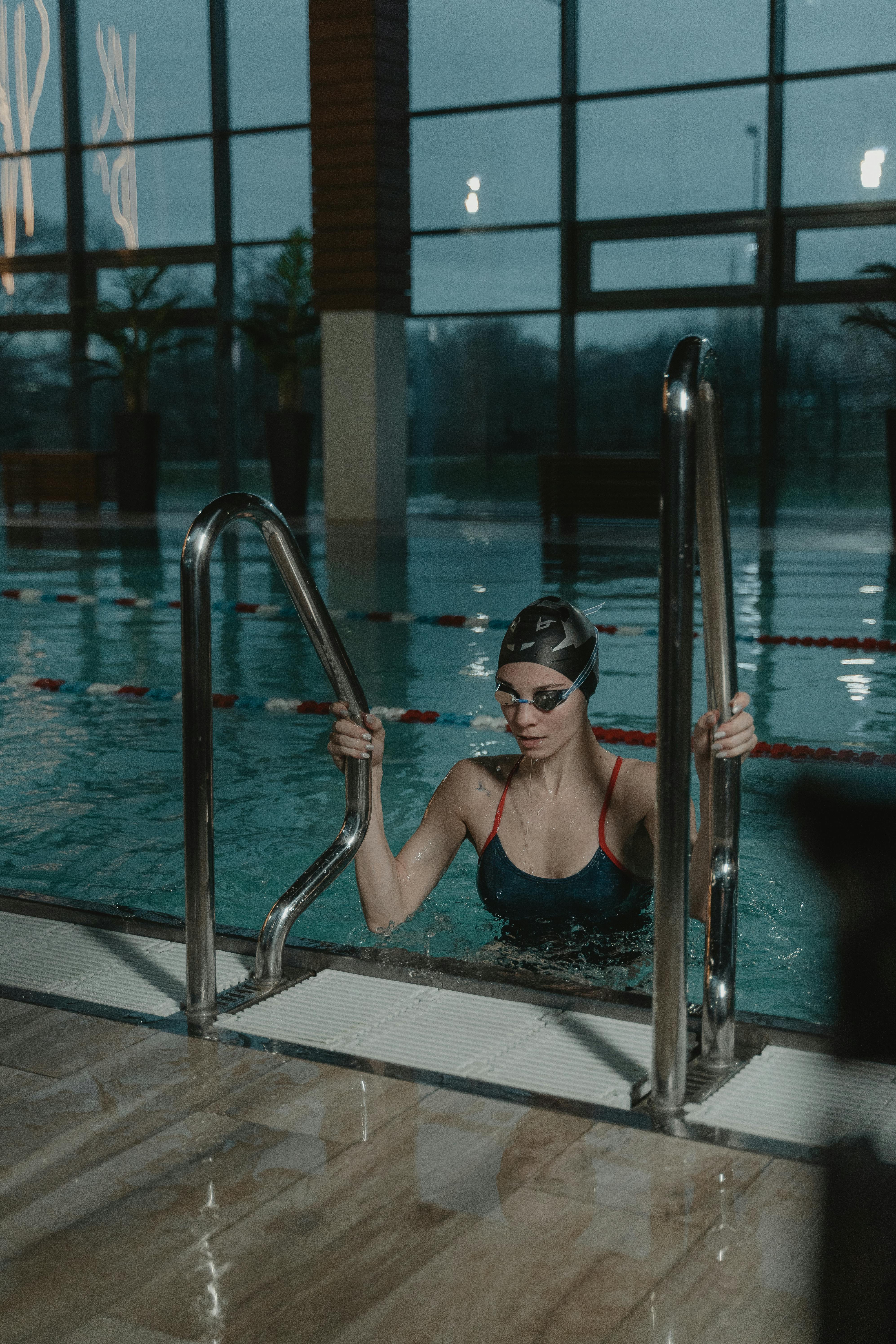 Swimmer Climbing Indoor Pool Ladder