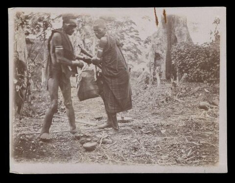 Two Indigenous Men Bartering Outdoors