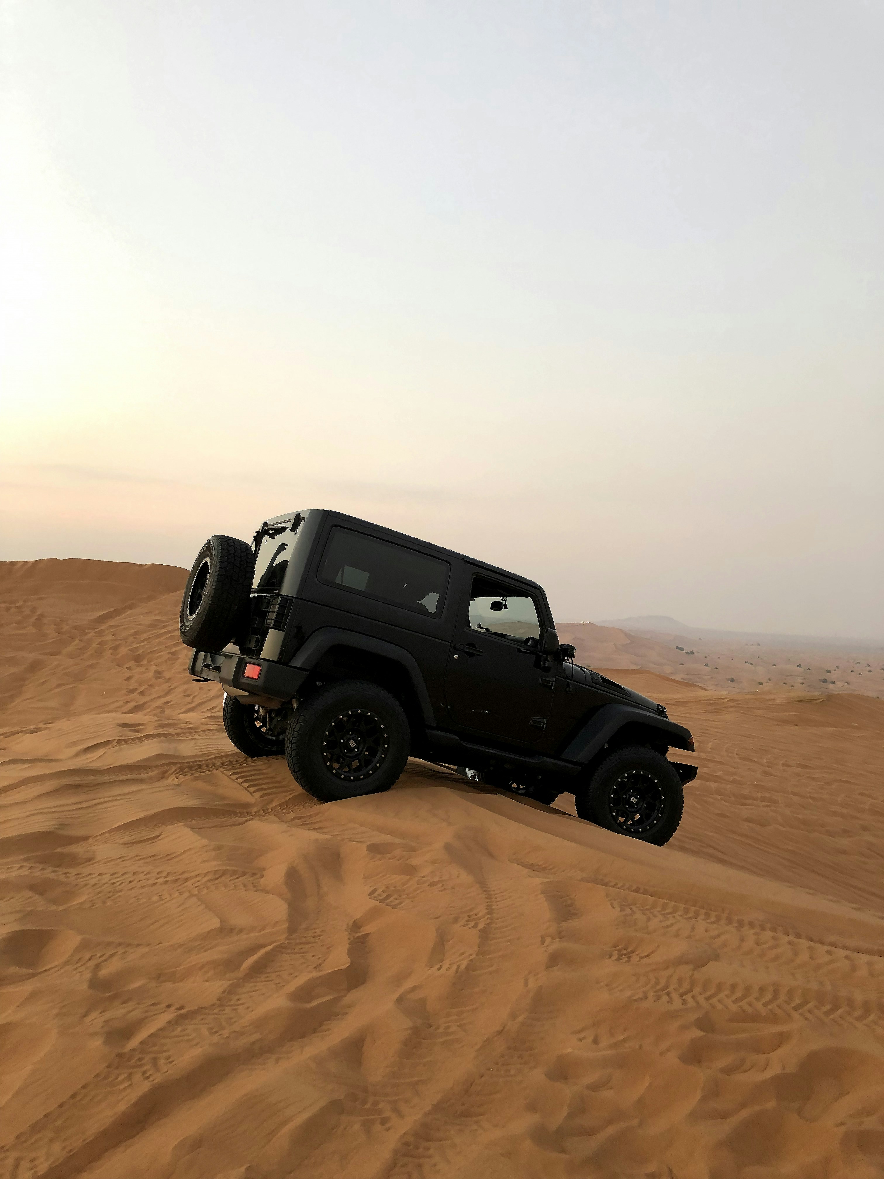 Black Offroad Jeep on Desert Dunes