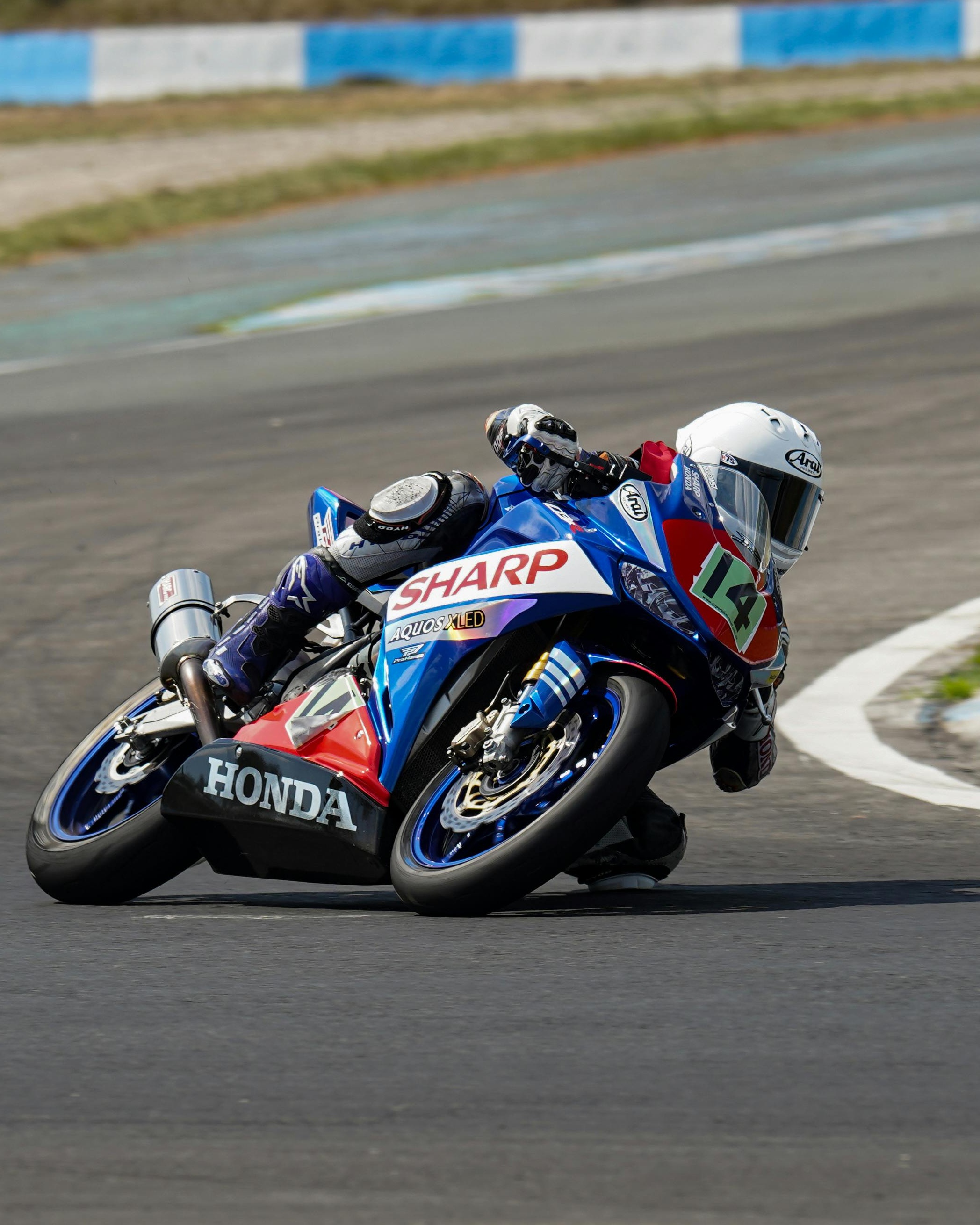 Motorcycle Racer Leans Into Track Turn