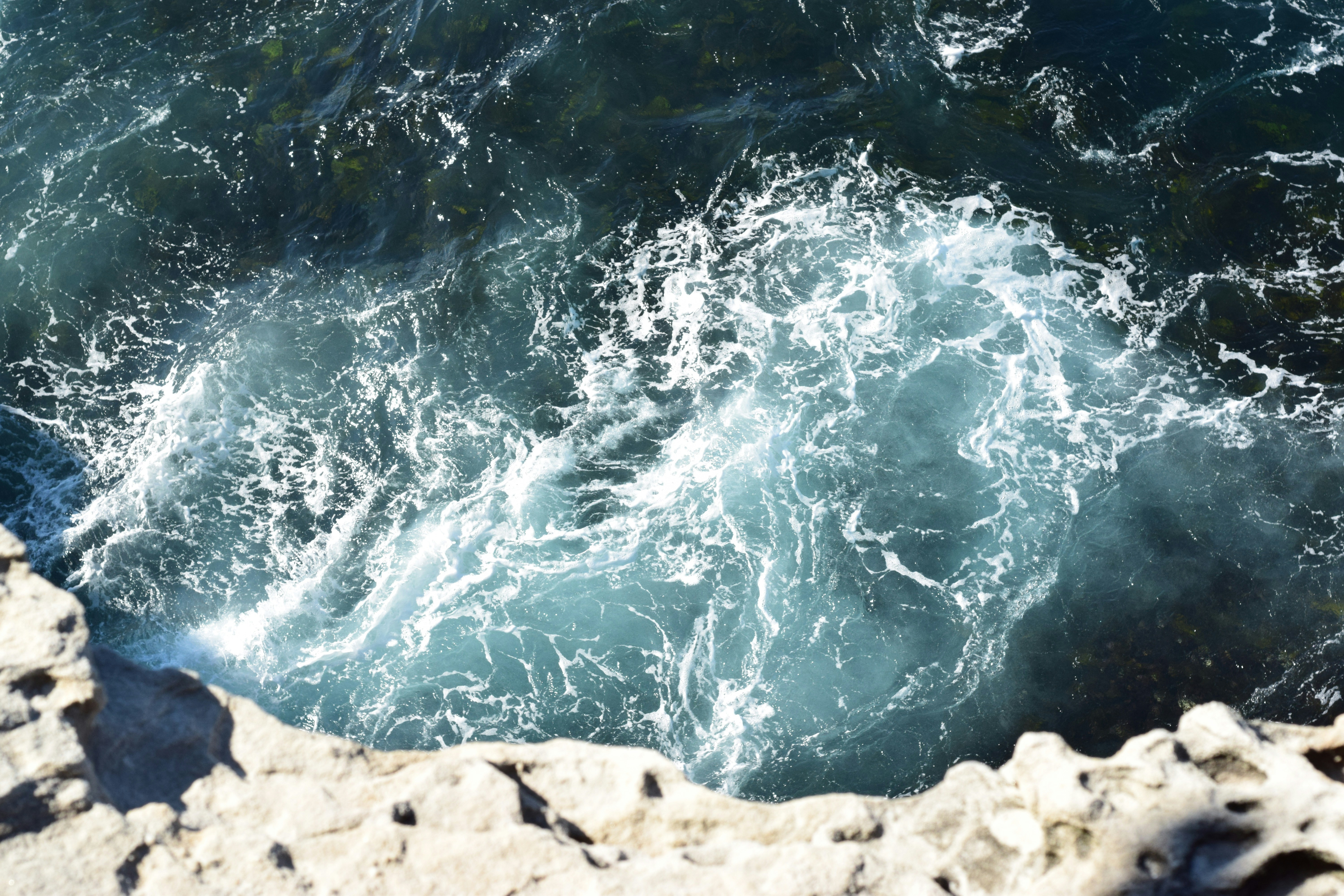 Sea Whirlpool by Rocky Cliff