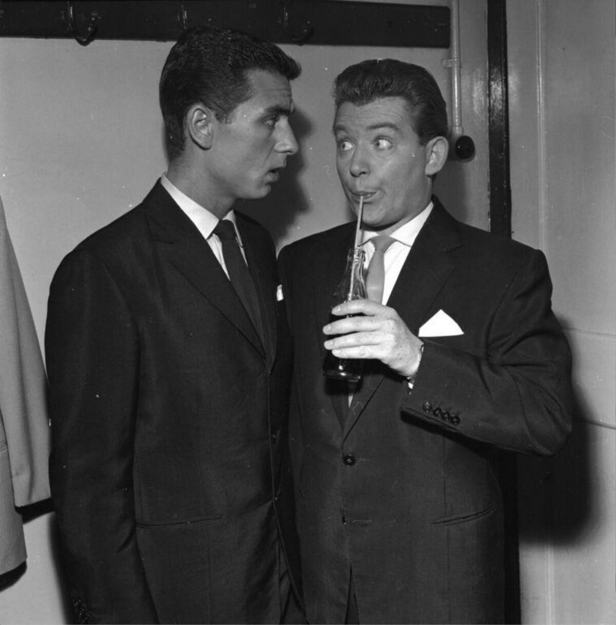 Two Men In Suits Share A Funny Moment