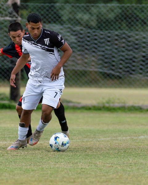 Two Soccer Players Competing for Ball