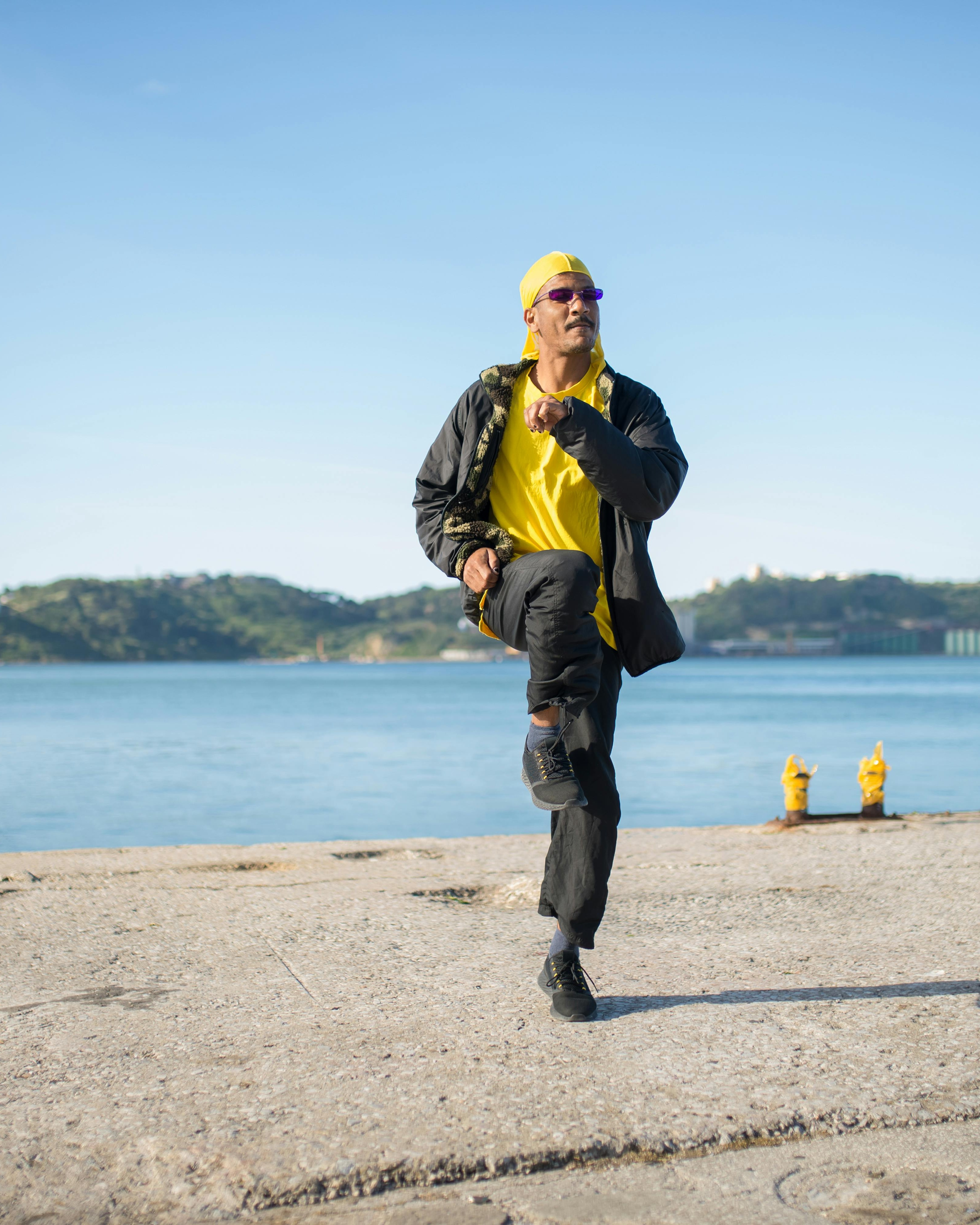 Man Dancing at Waterfront Pier
