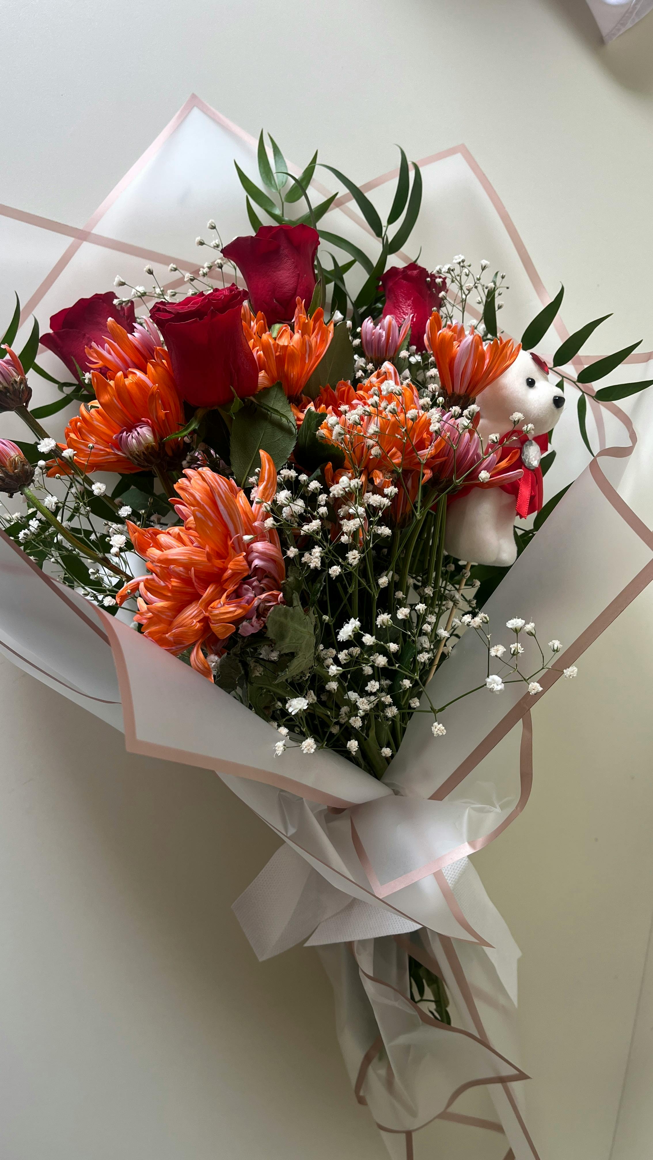 Flower bouquet with small teddy bear