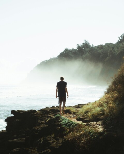 Man Walking on Coastal Cliff Path