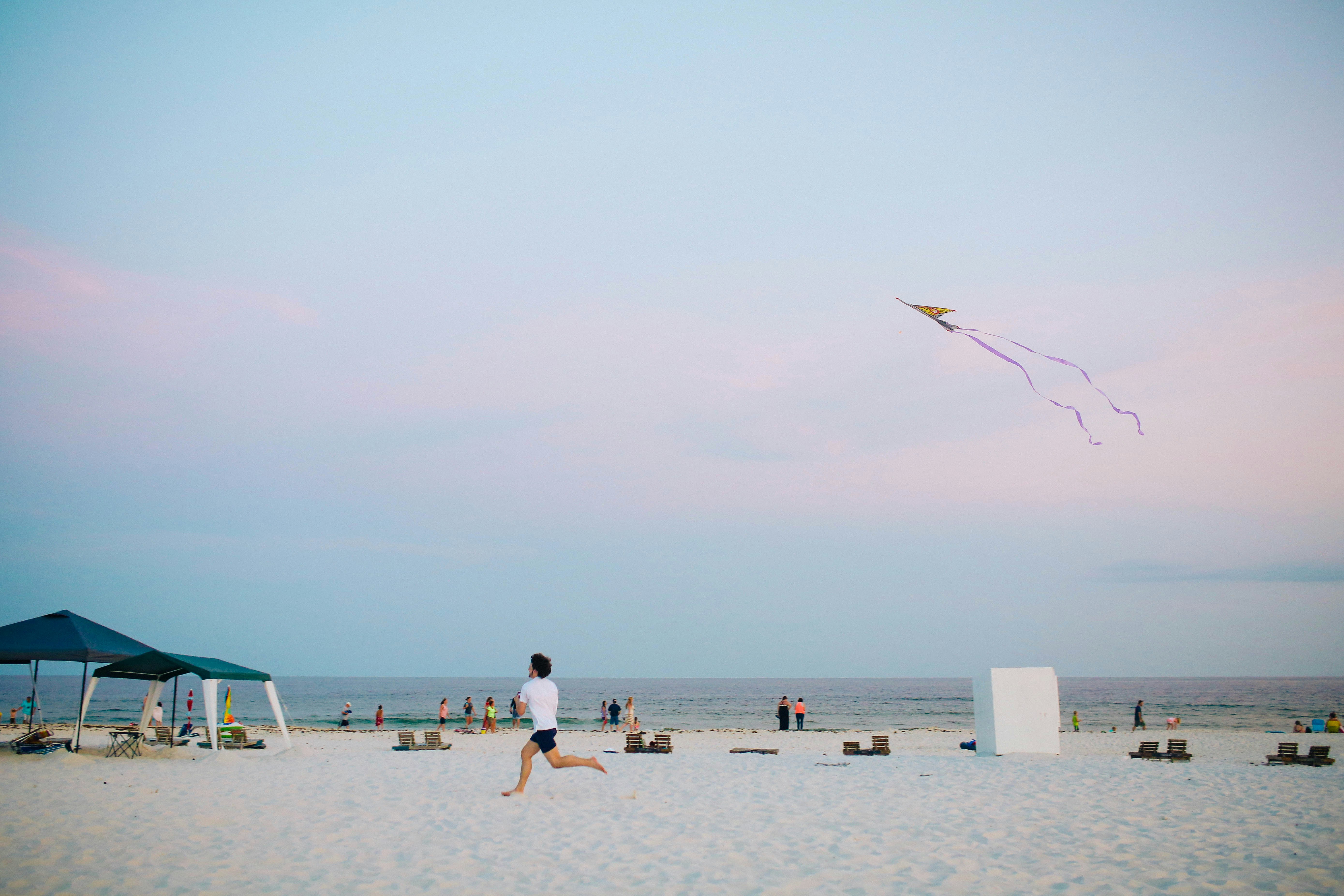 Man Flying Kite on Beach