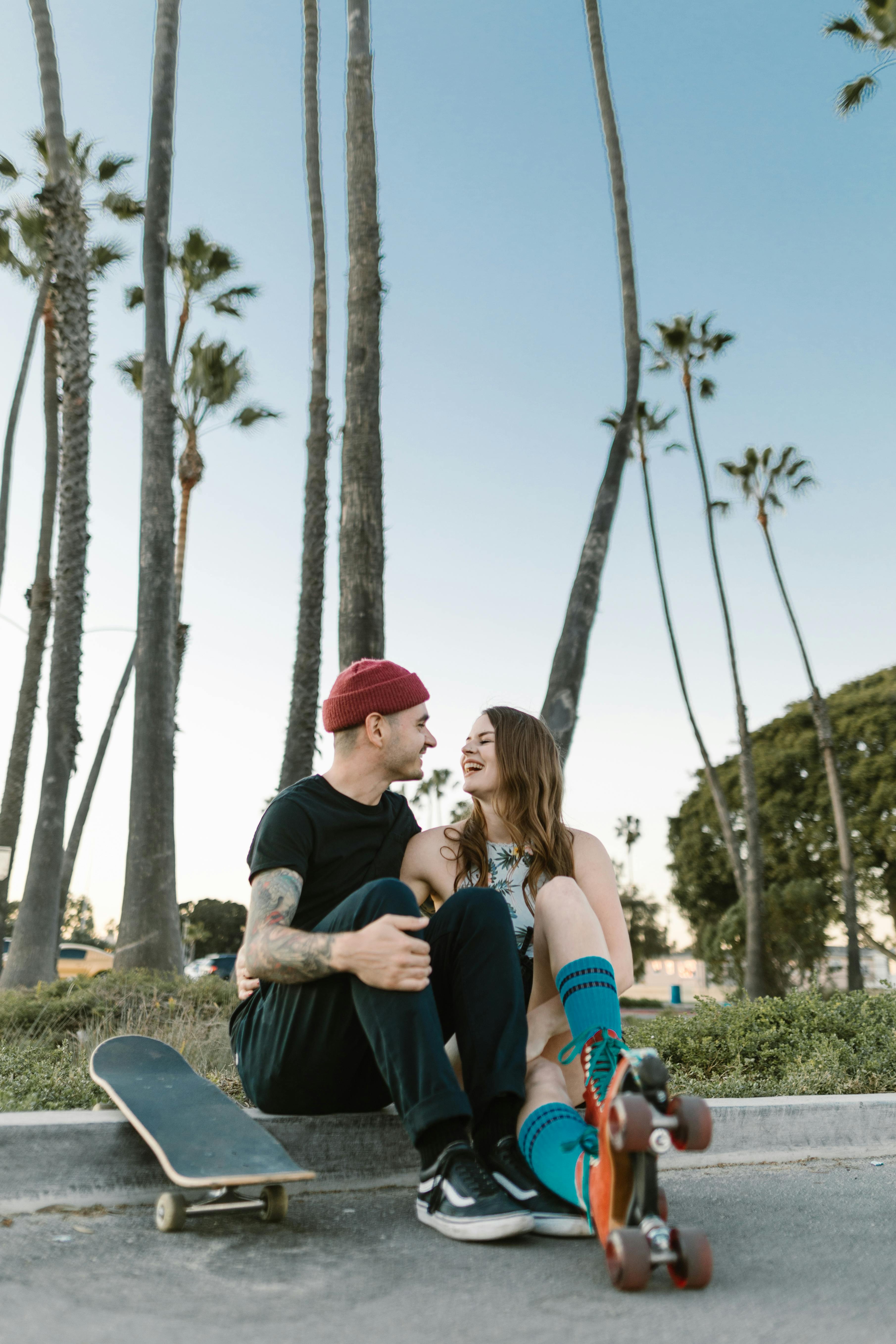 Laughing Couple with Skates by Palm Trees