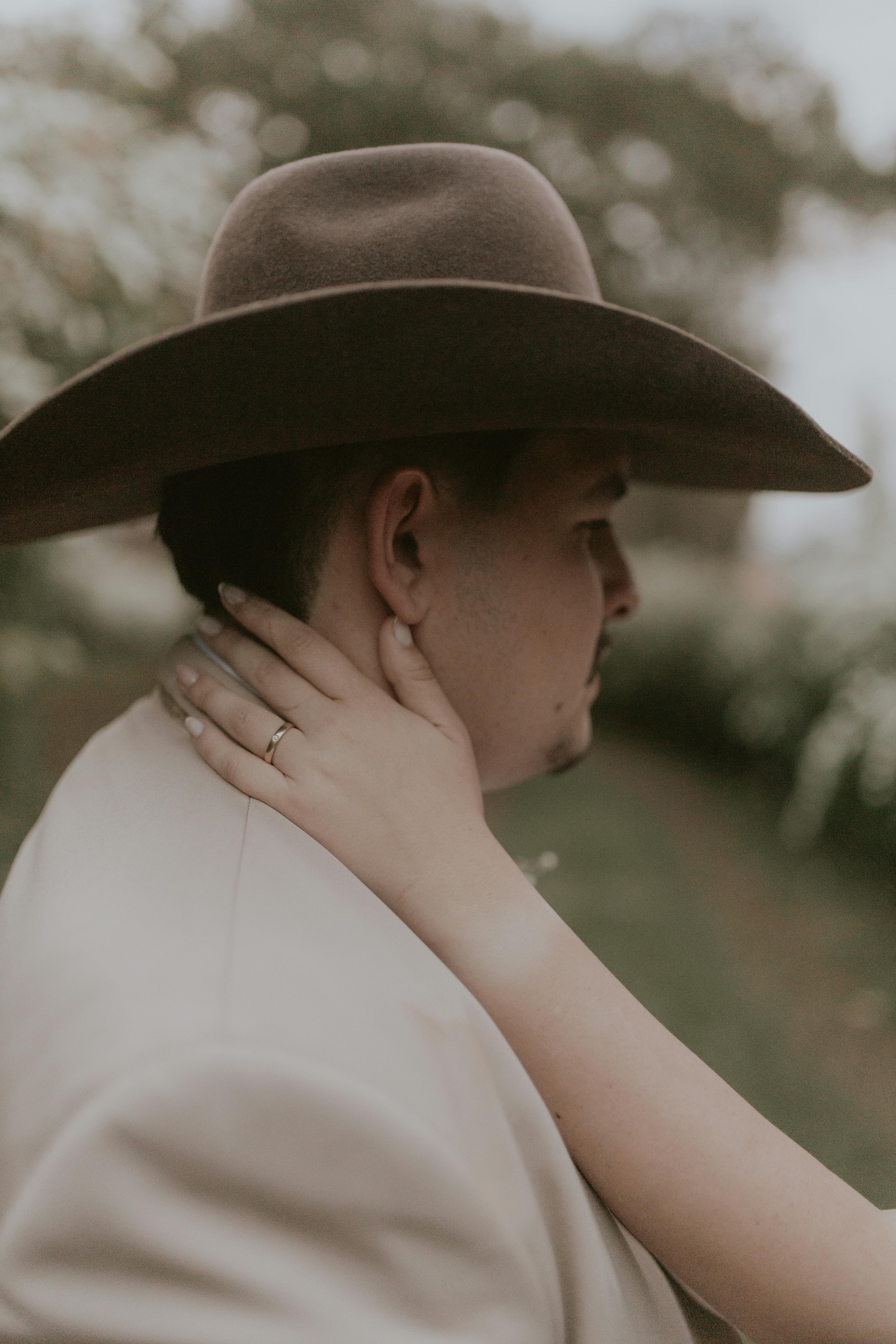 Man in Cowboy Hat with Partner's Hand on Neck