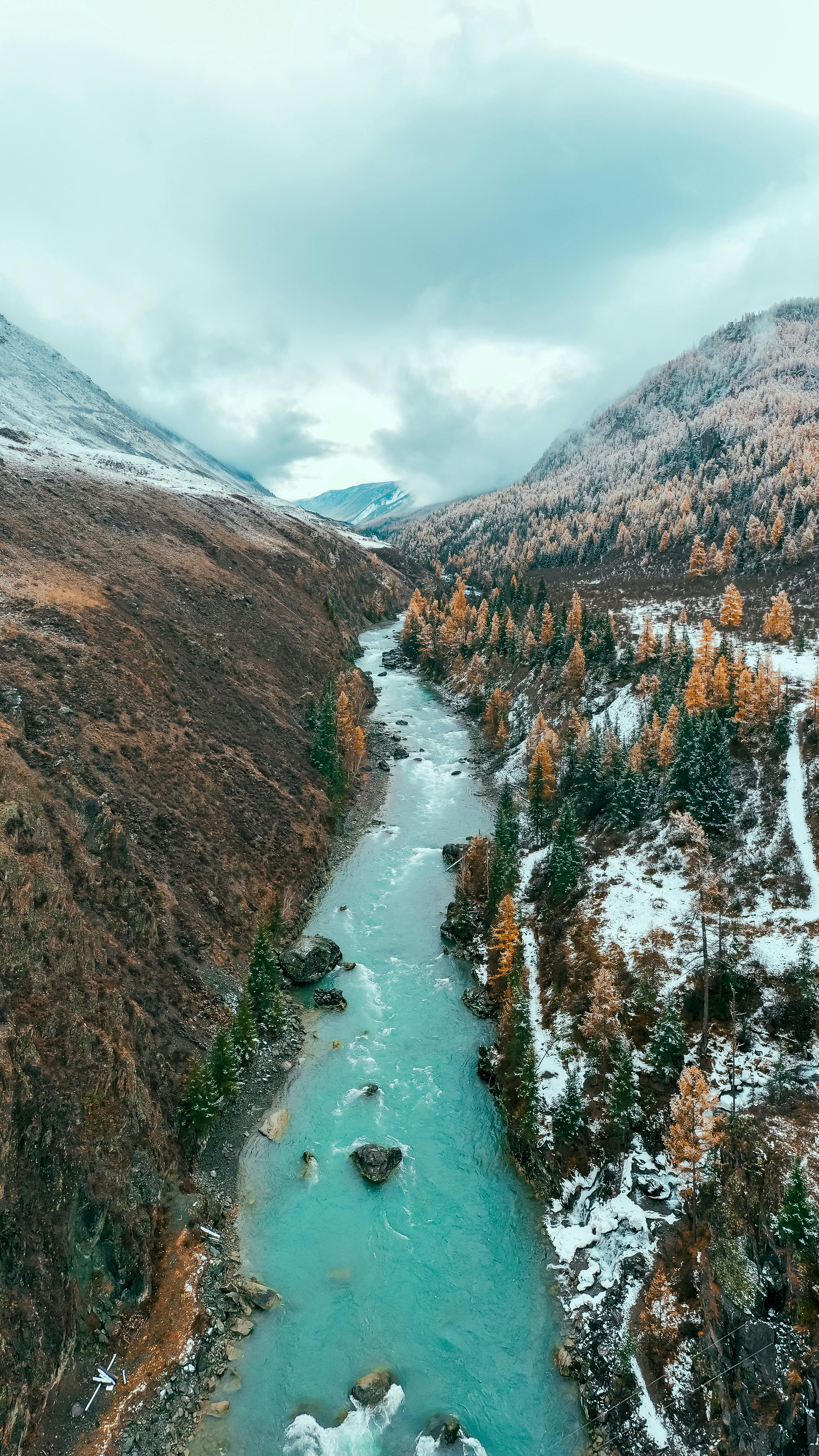 Turquoise River in Snowy Mountain Valley