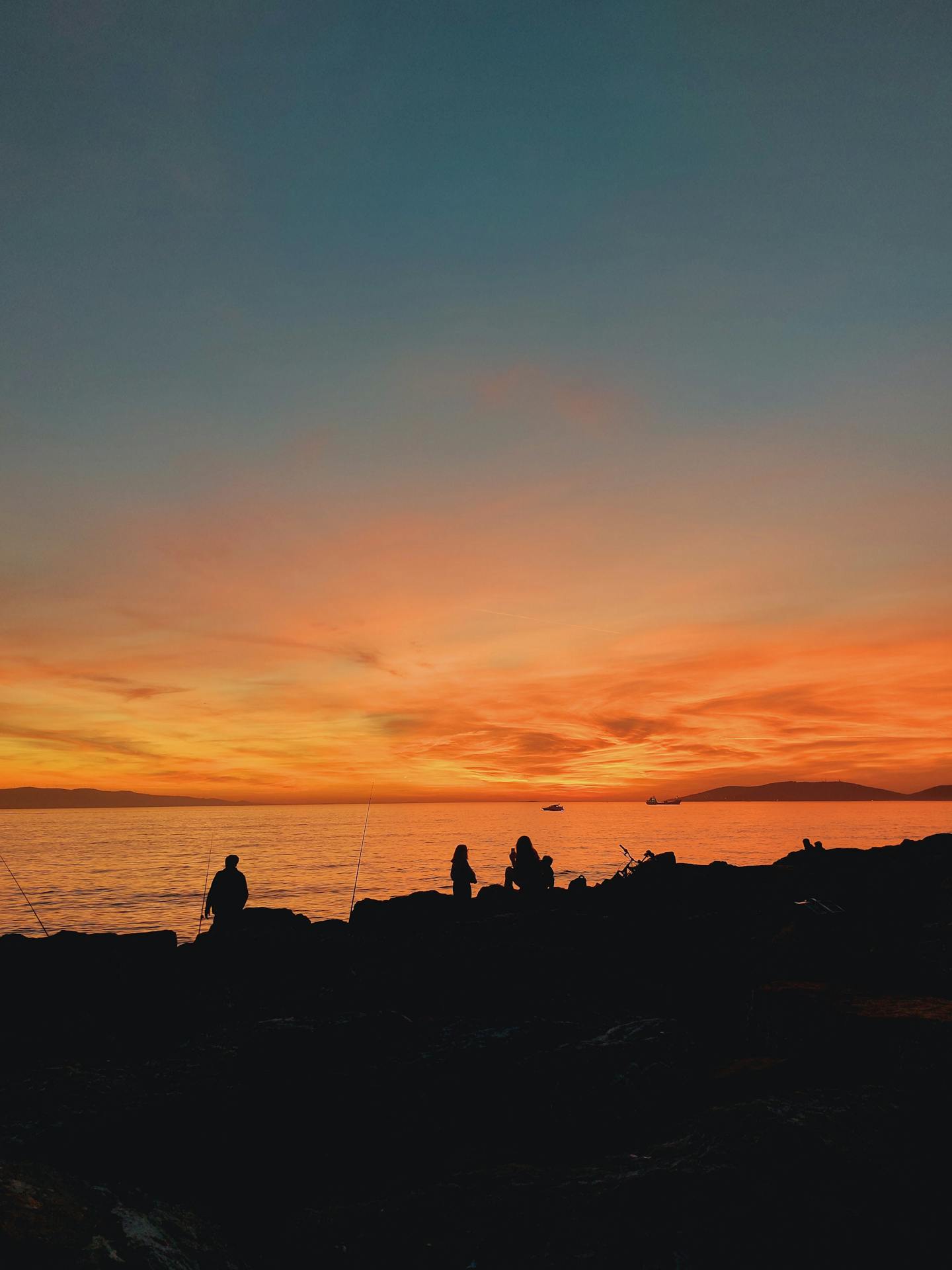 Coastal Sunset With People Silhouettes