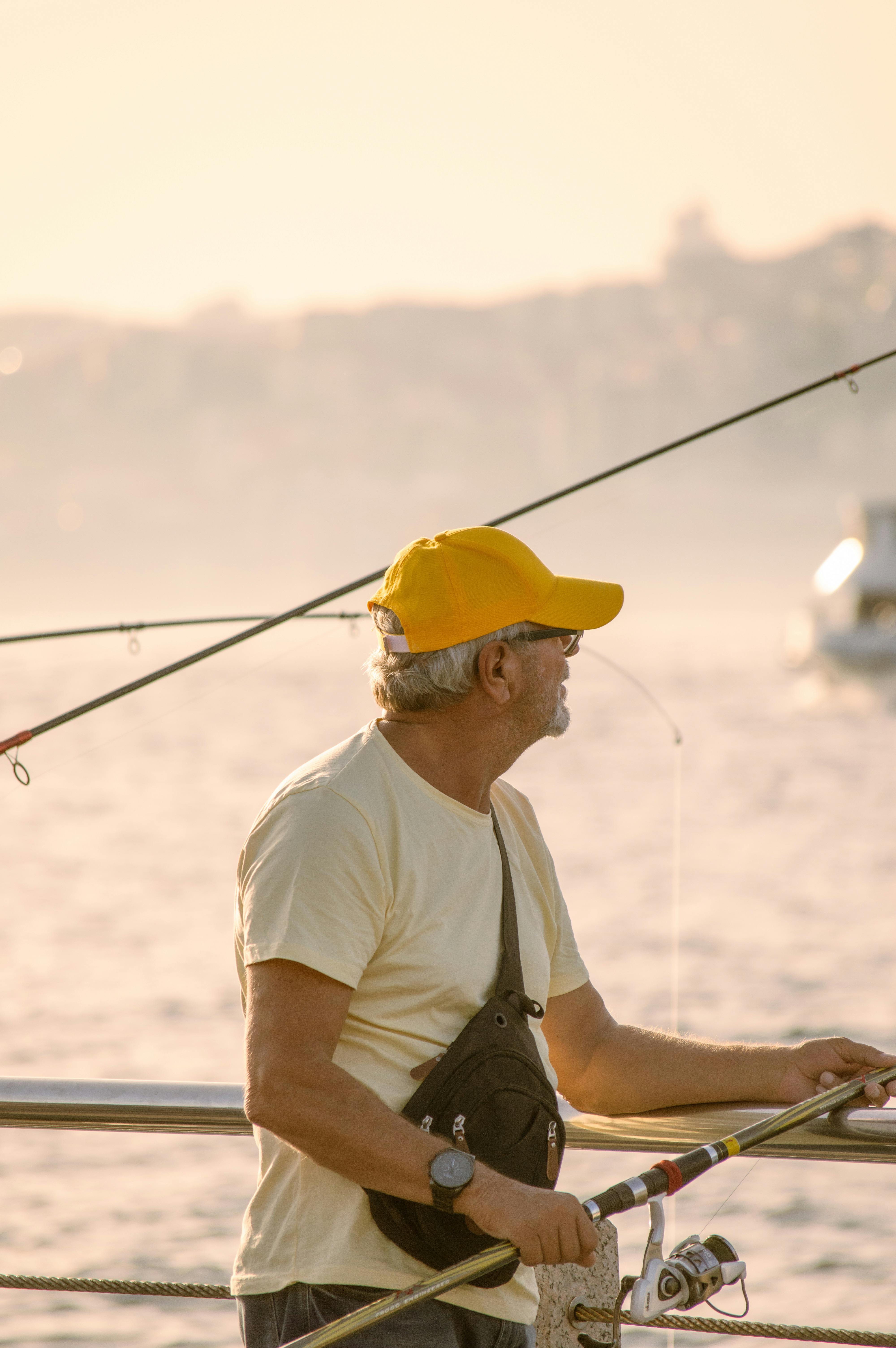 Older Man Fishing By The Sea