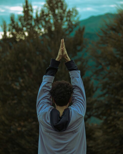 Person Doing Yoga Overlooking Mountains