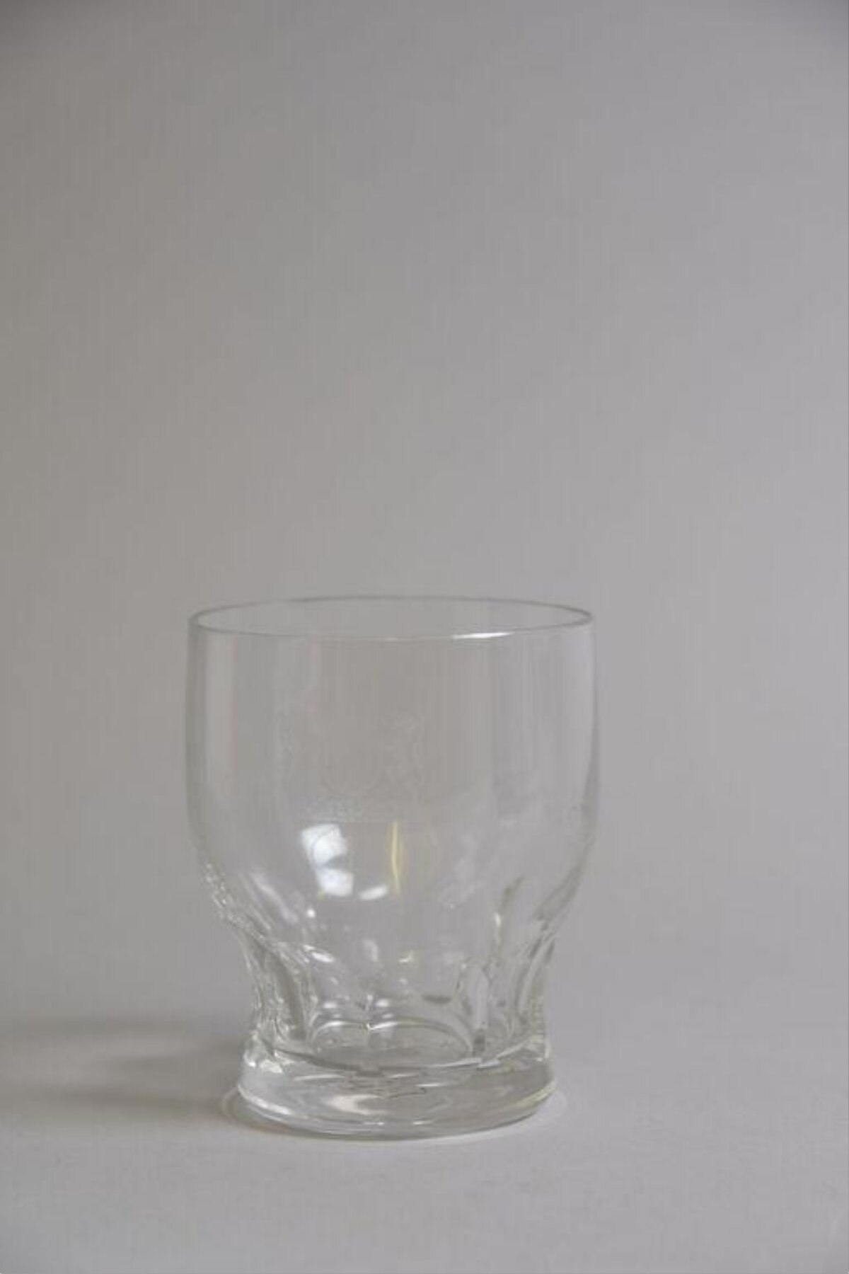Empty Clear Glass on Gray Background