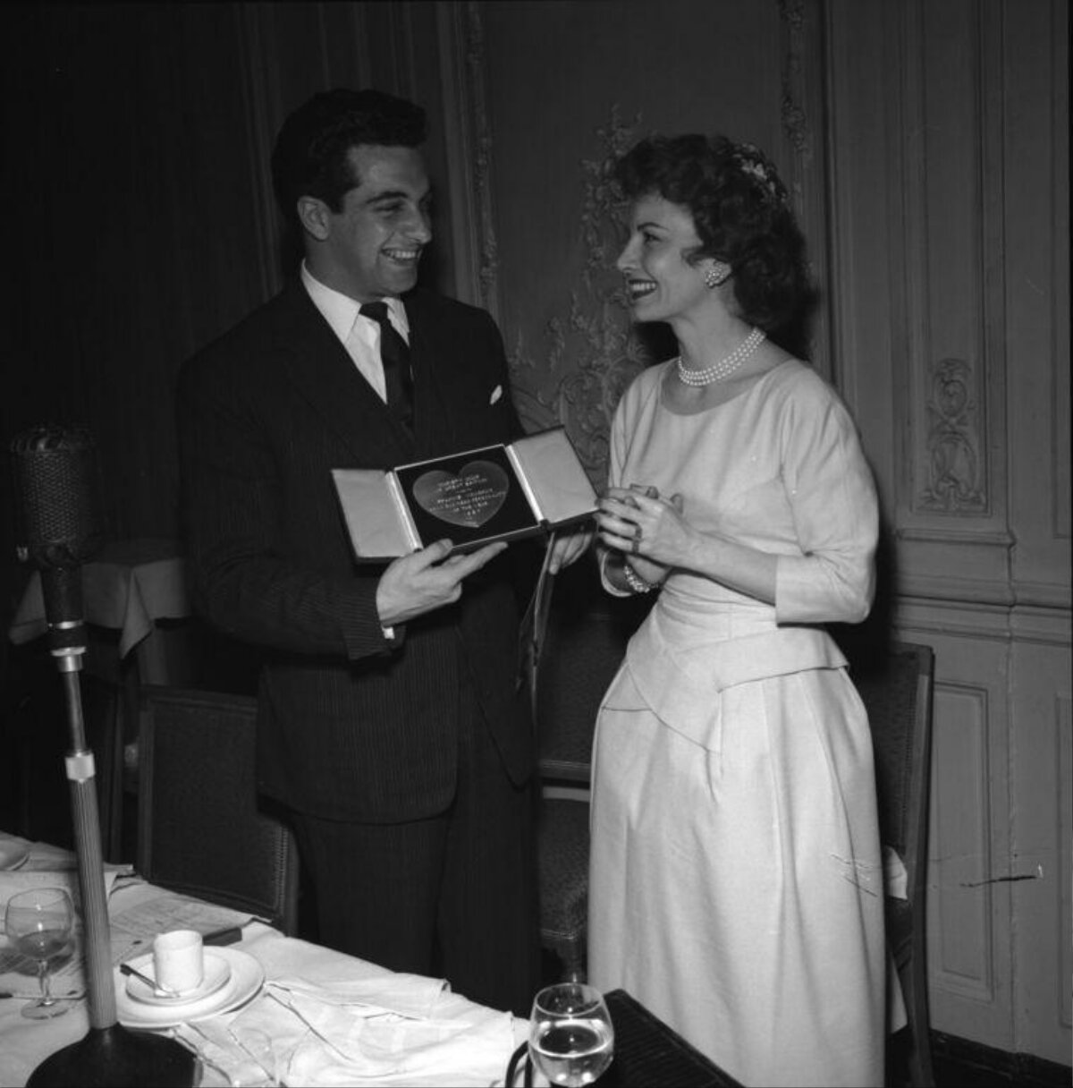 Man Presents Award to Woman at Dinner