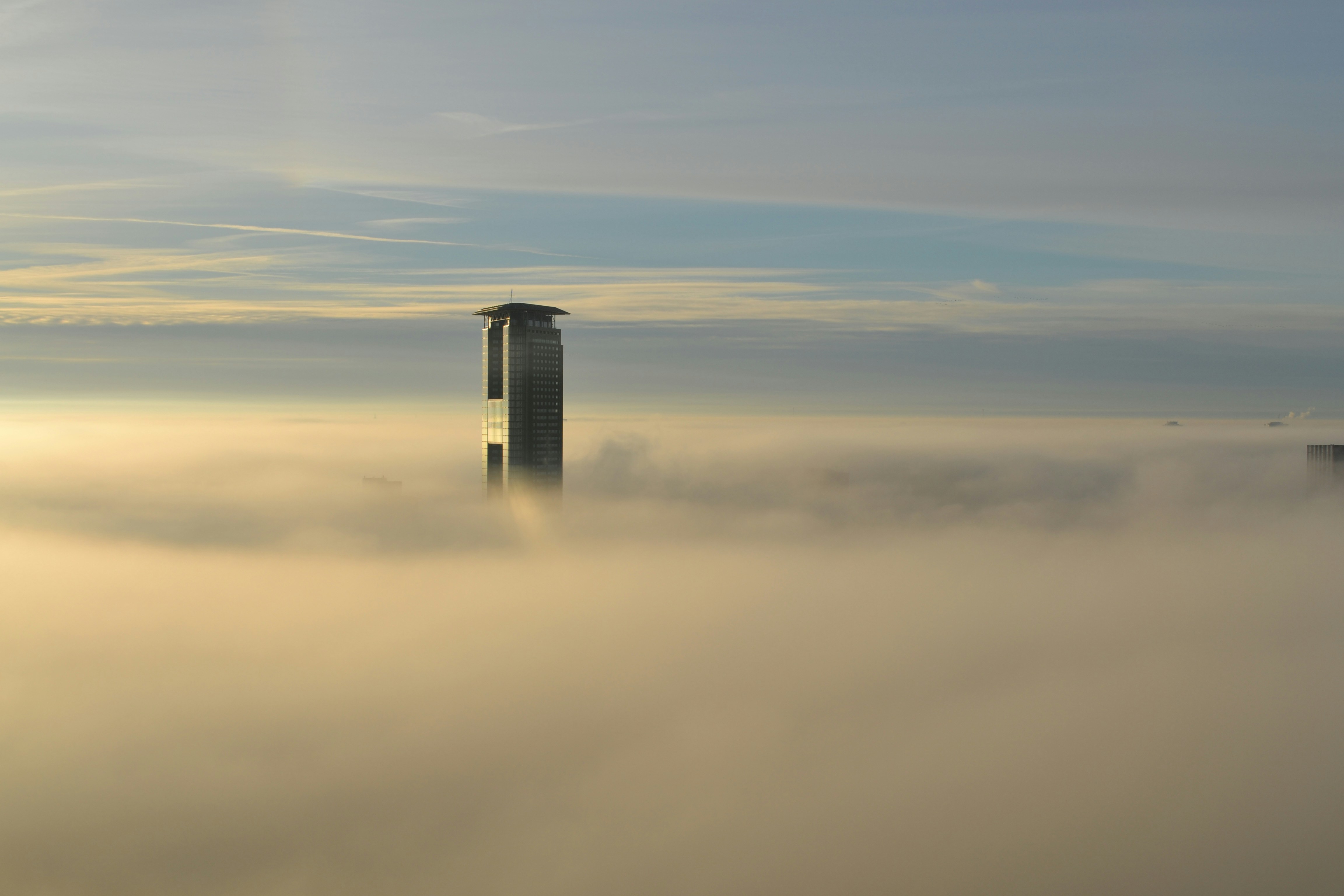 Skyscraper Above Morning Fog