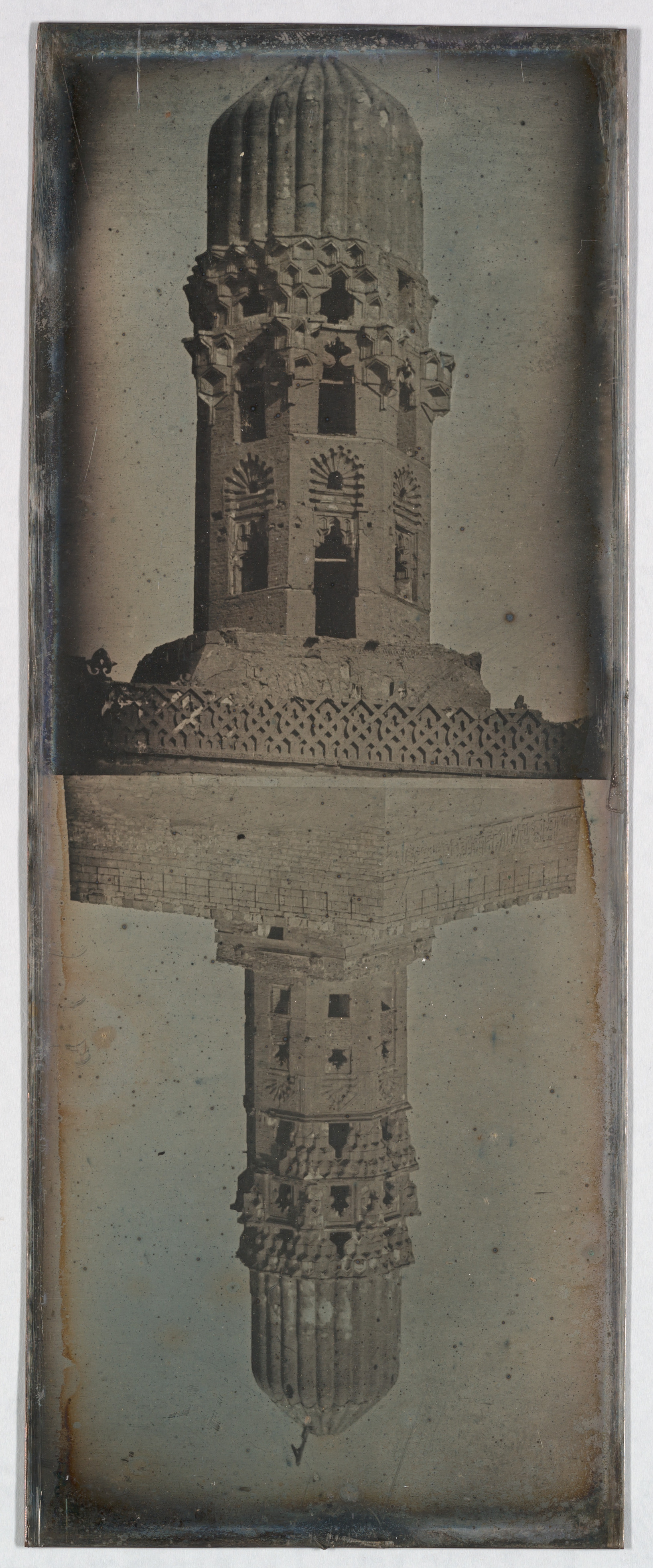Historical Minaret and Water Reflection