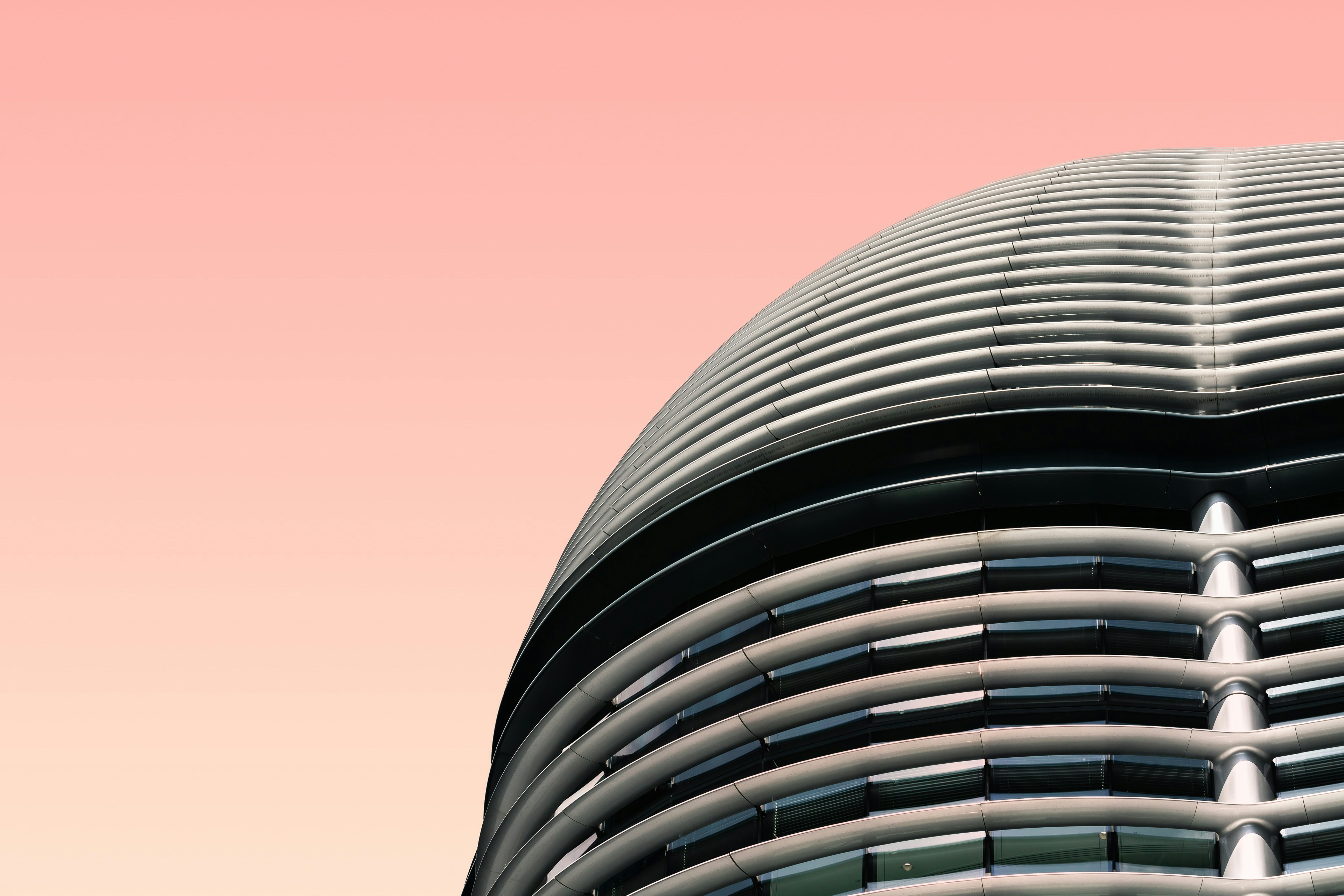Curved Modern Building Under Pink Sky