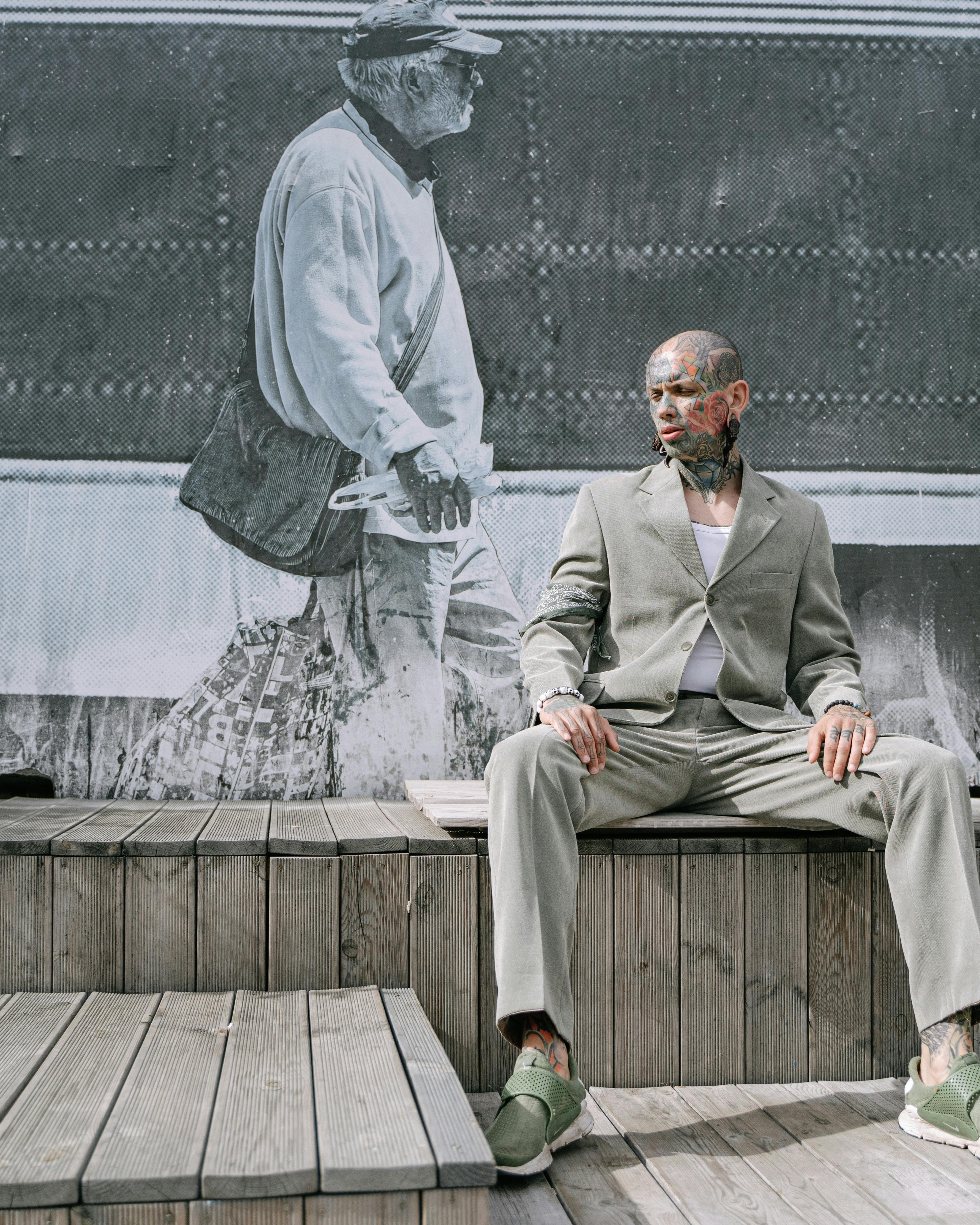 Tattooed Man in Suit by Street Mural