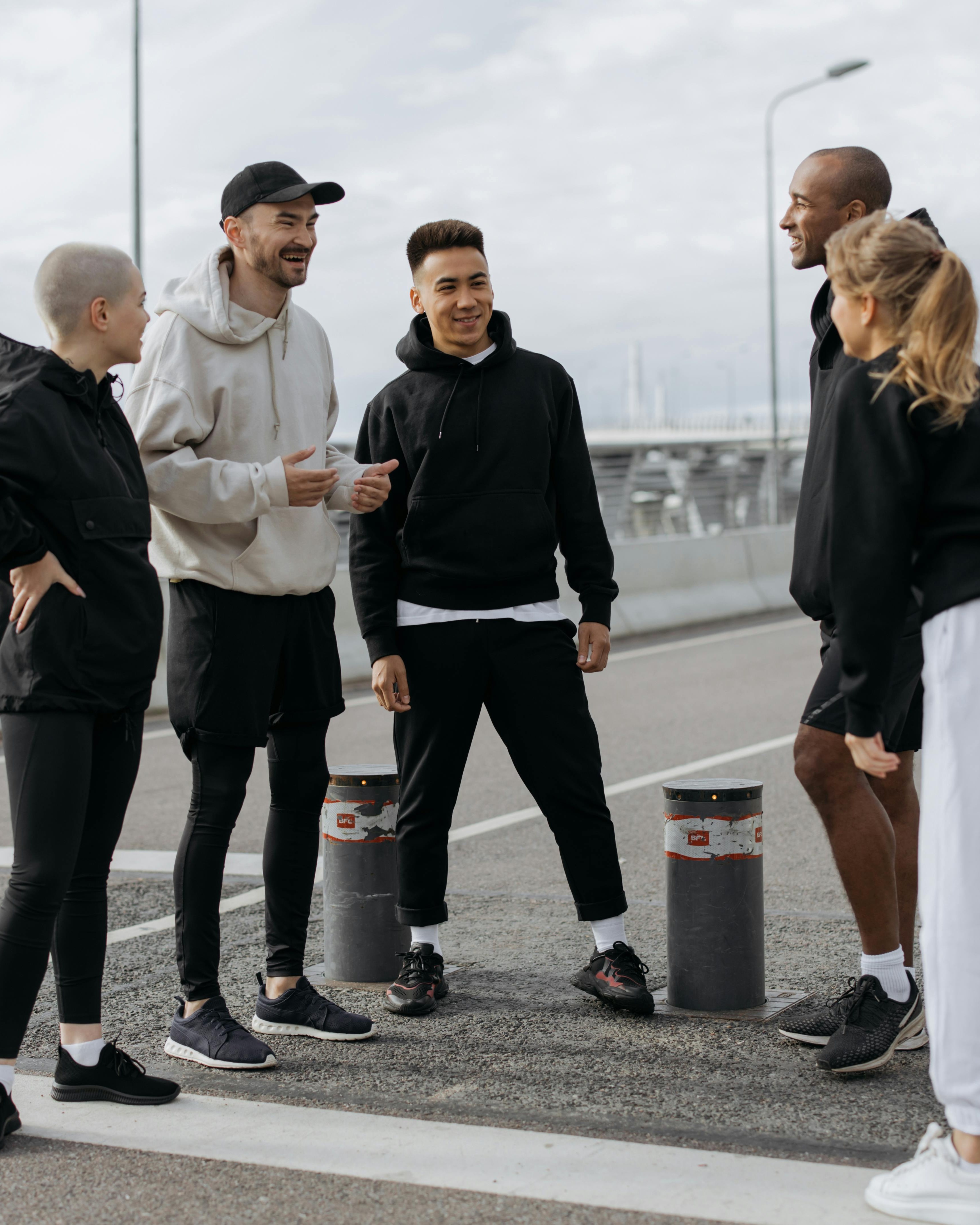Five Athletic Friends Chatting Outdoors
