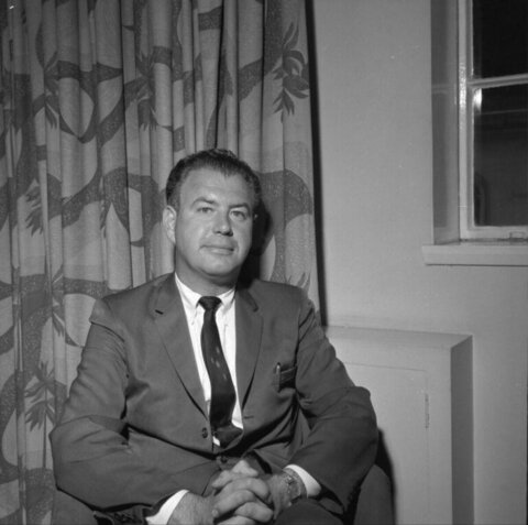 Black and White Portrait of Seated Man in Suit