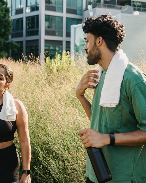 Two Runners Resting After Workout Outdoors