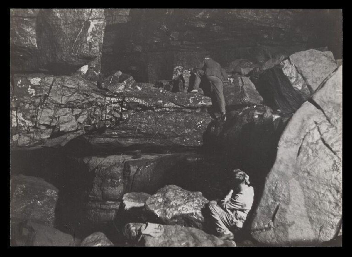 Two Explorers in a Rocky Cave