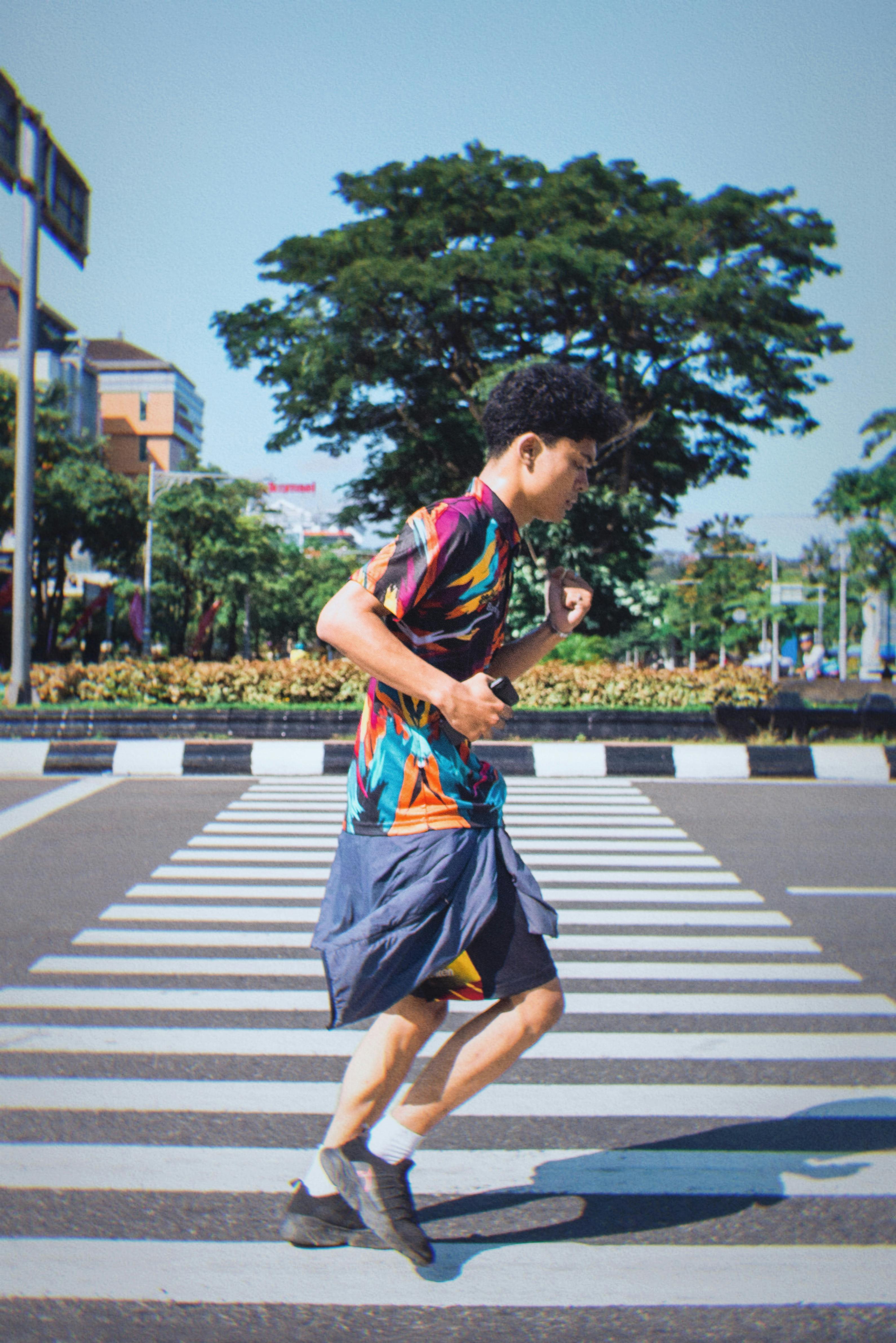 Man Jogging Across Urban Crosswalk