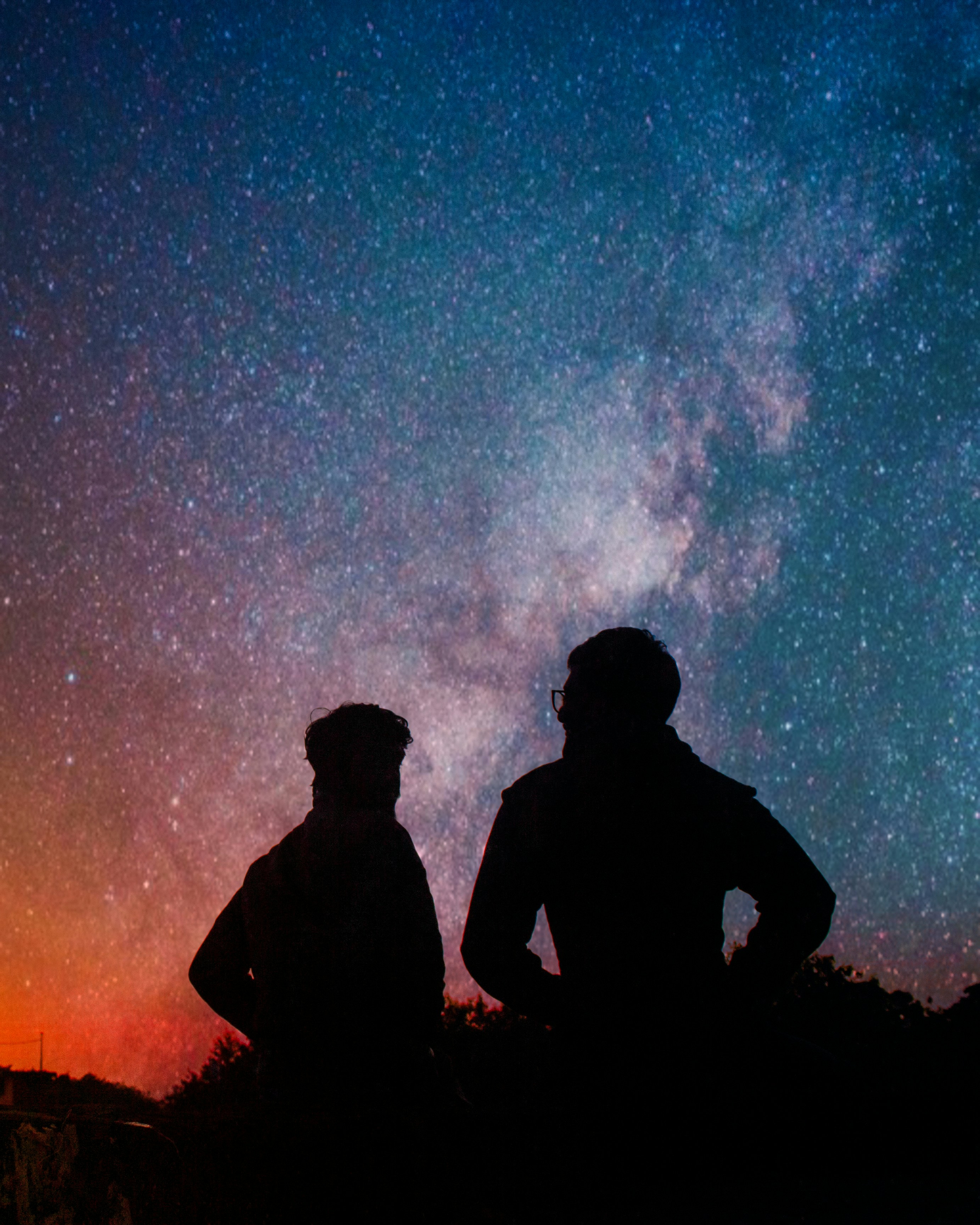 Two People Stargazing Under Night Sky
