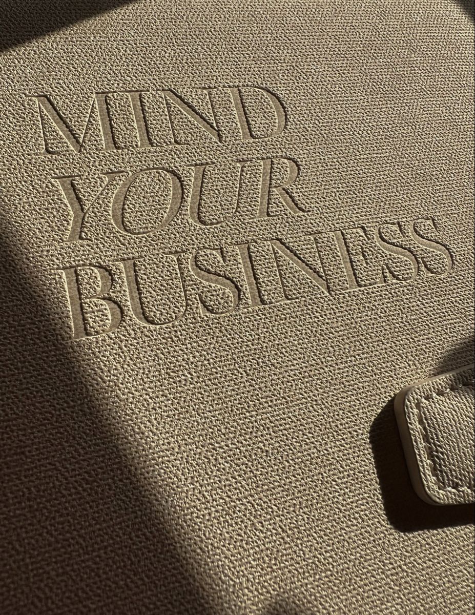Embossed 'Mind Your Business' on Beige Fabric