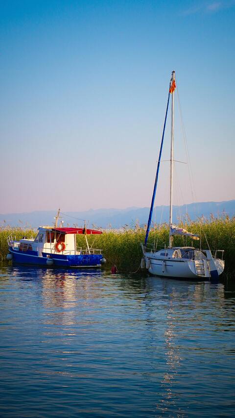 Two Boats Moored on Calm Lake