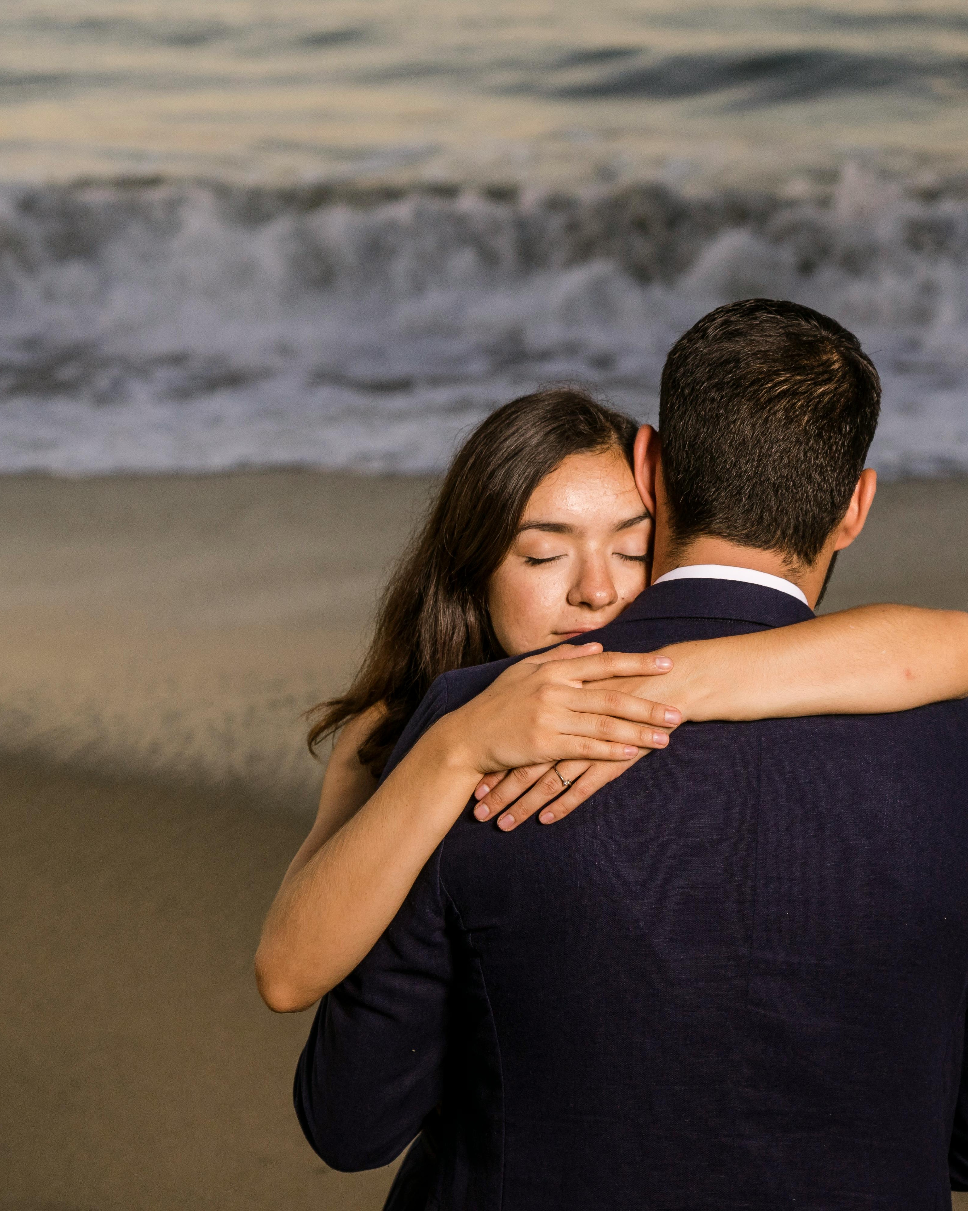 Couple Embracing on Sandy Beach