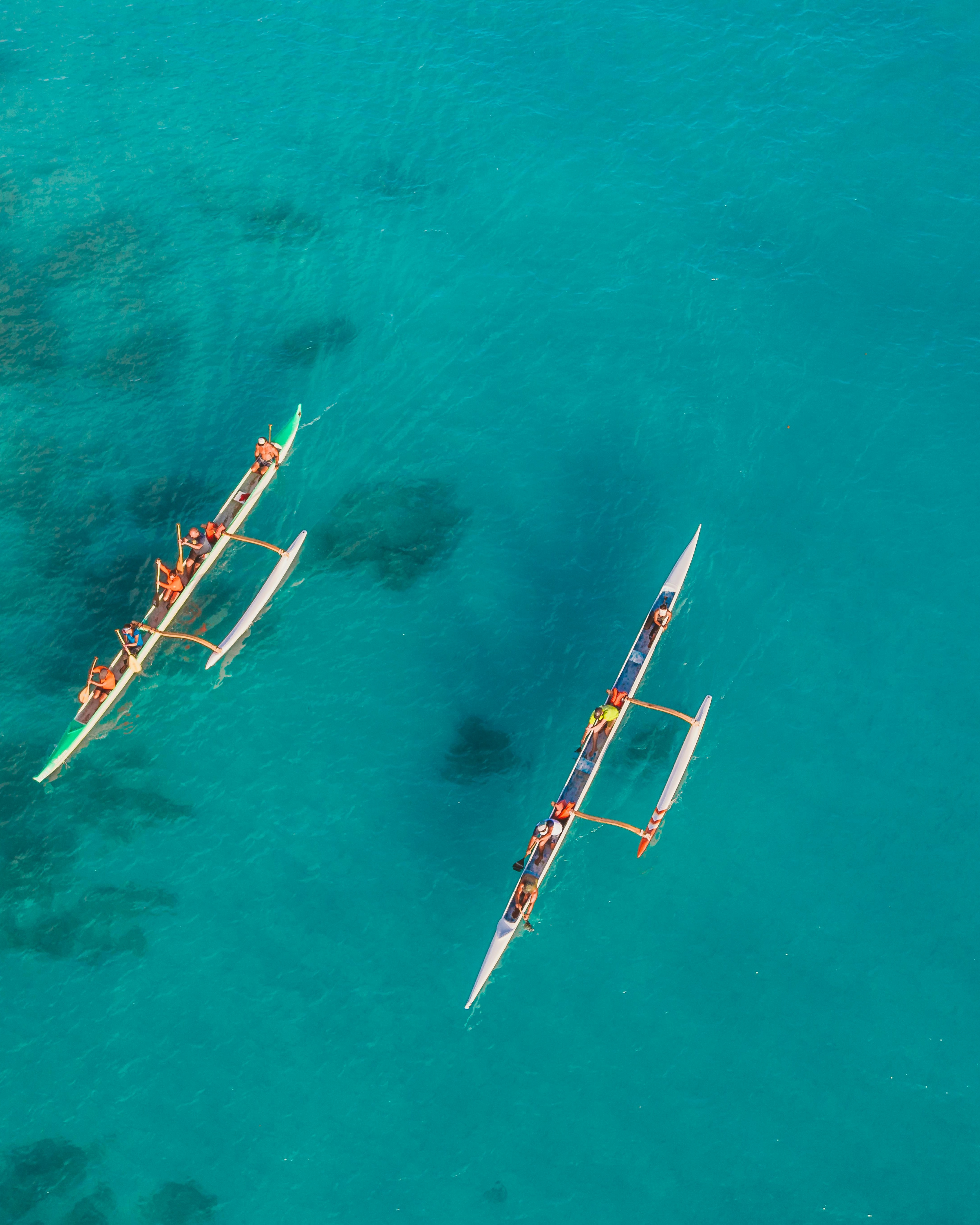Two Outrigger Canoes on Turquoise Ocean