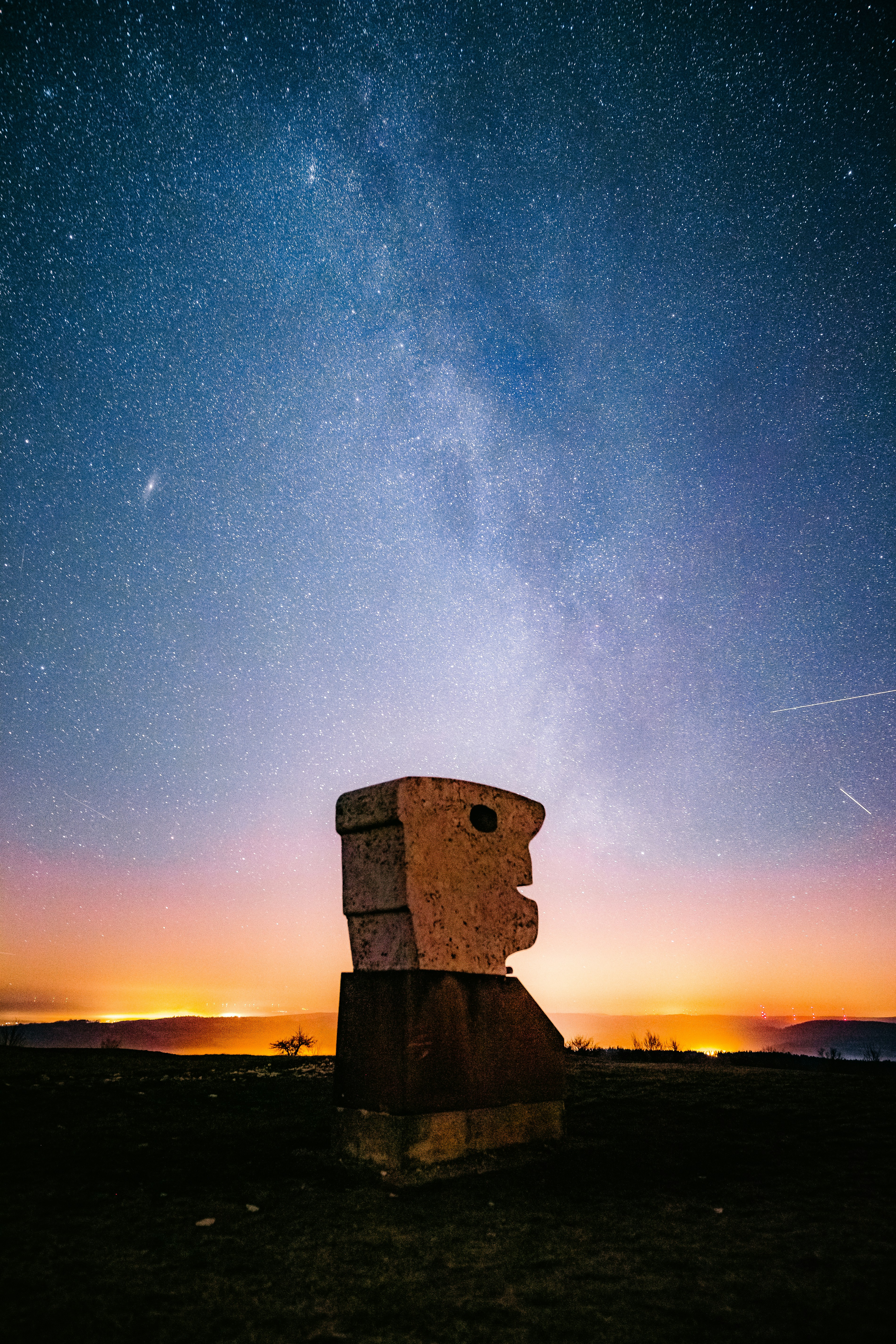 Stone Head Sculpture under Starry Night Sky