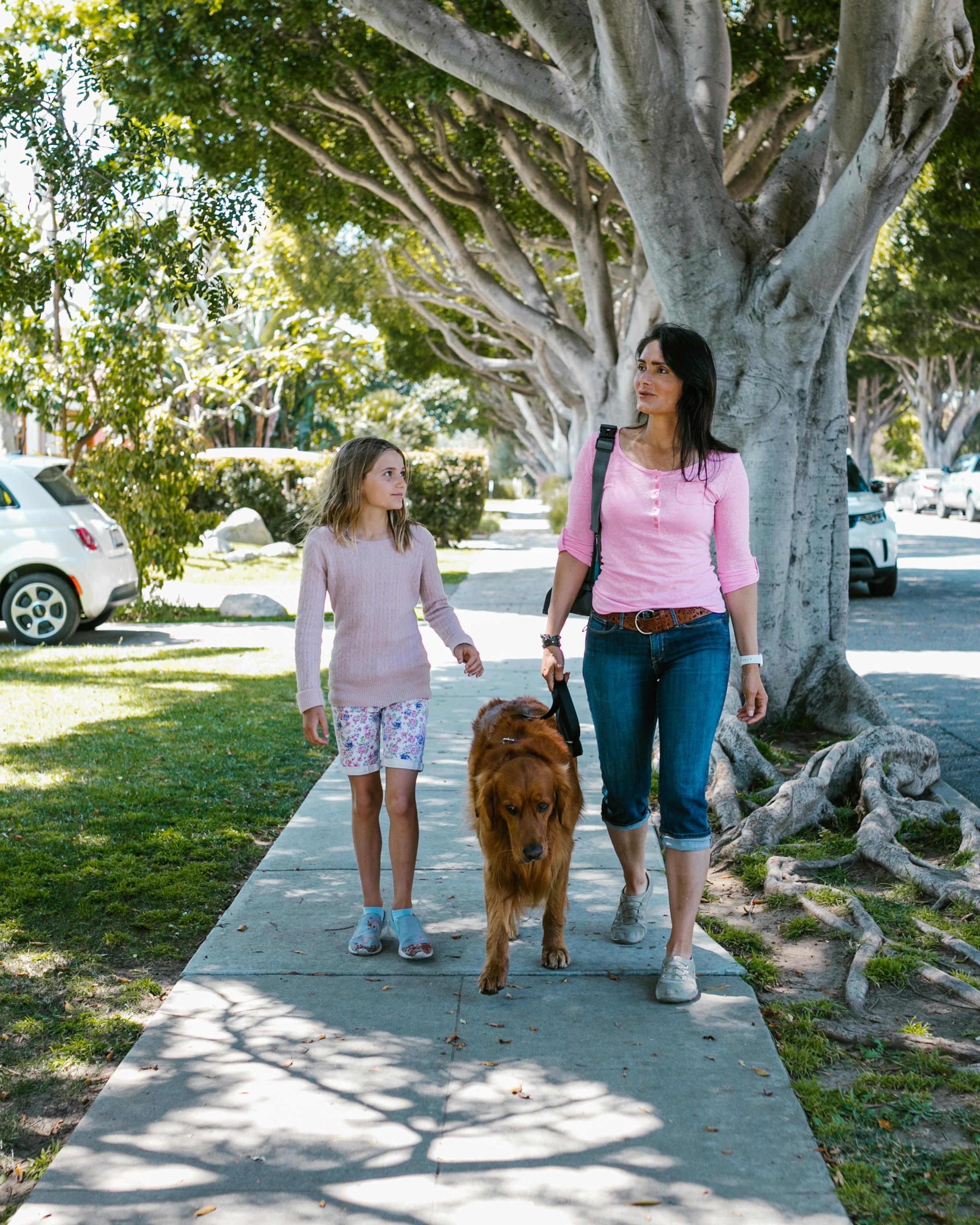 Woman and Girl Walking a Golden Retriever