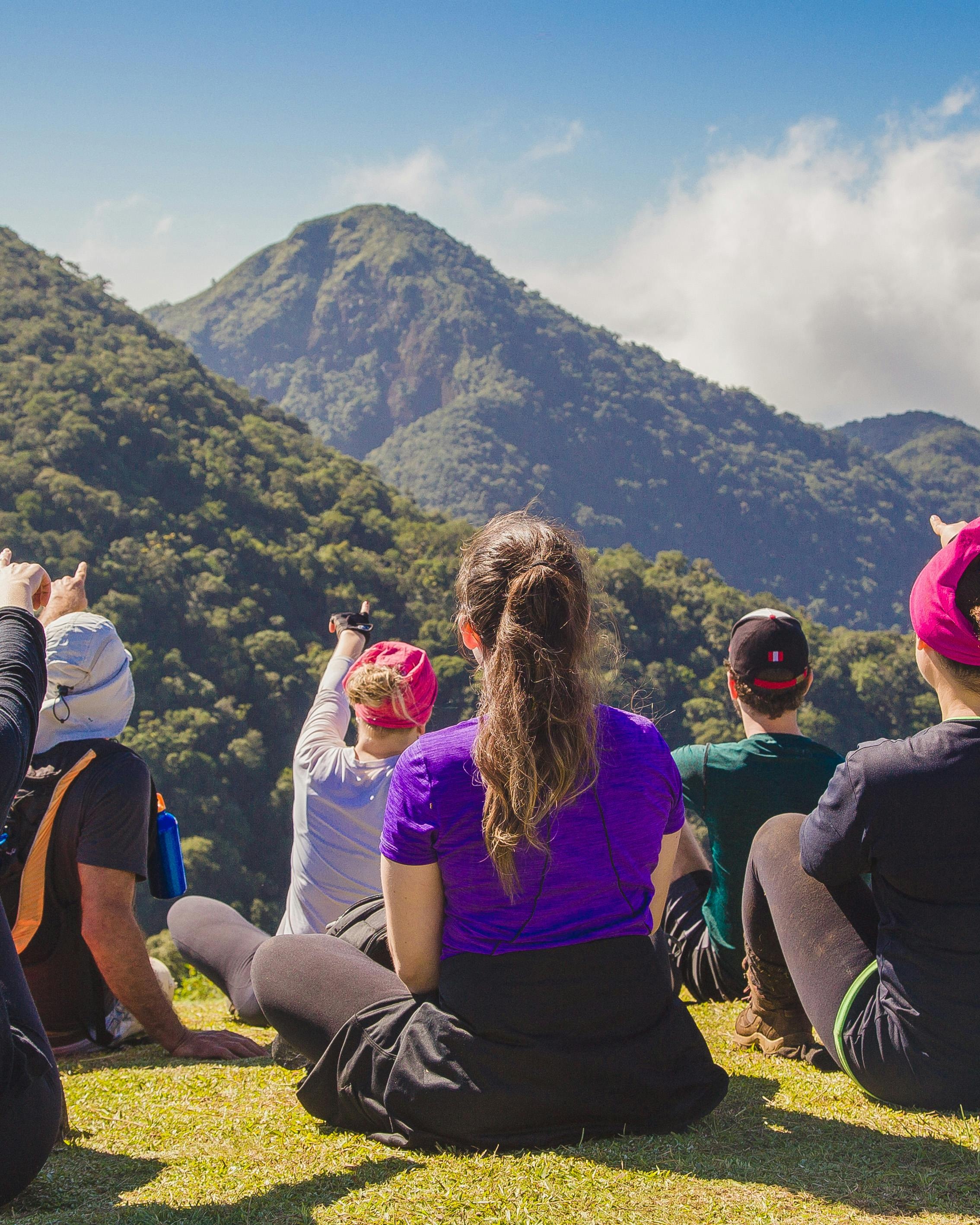 Hikers Overlooking Lush Green Mountains
