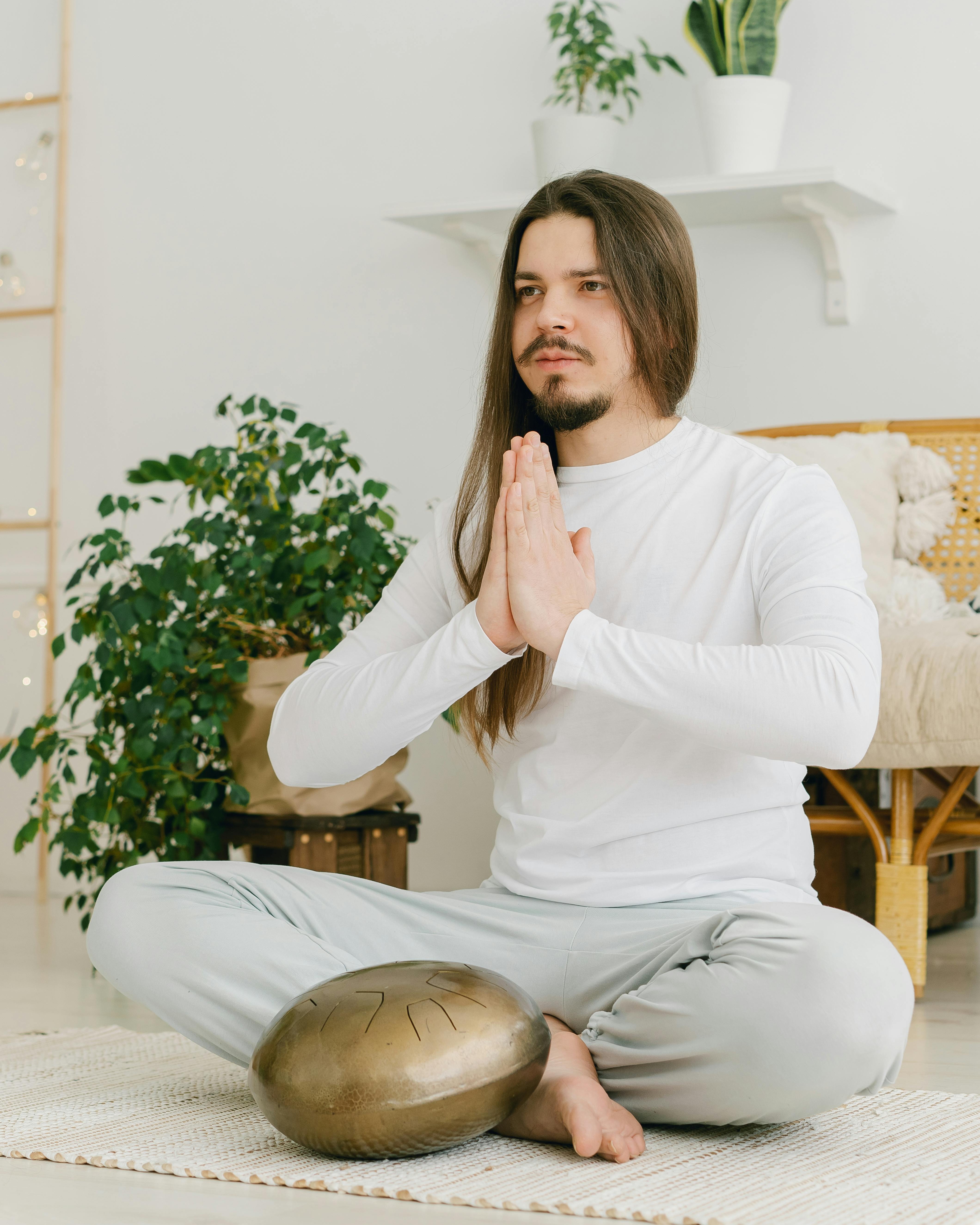 Man Meditating With Handpan Drum