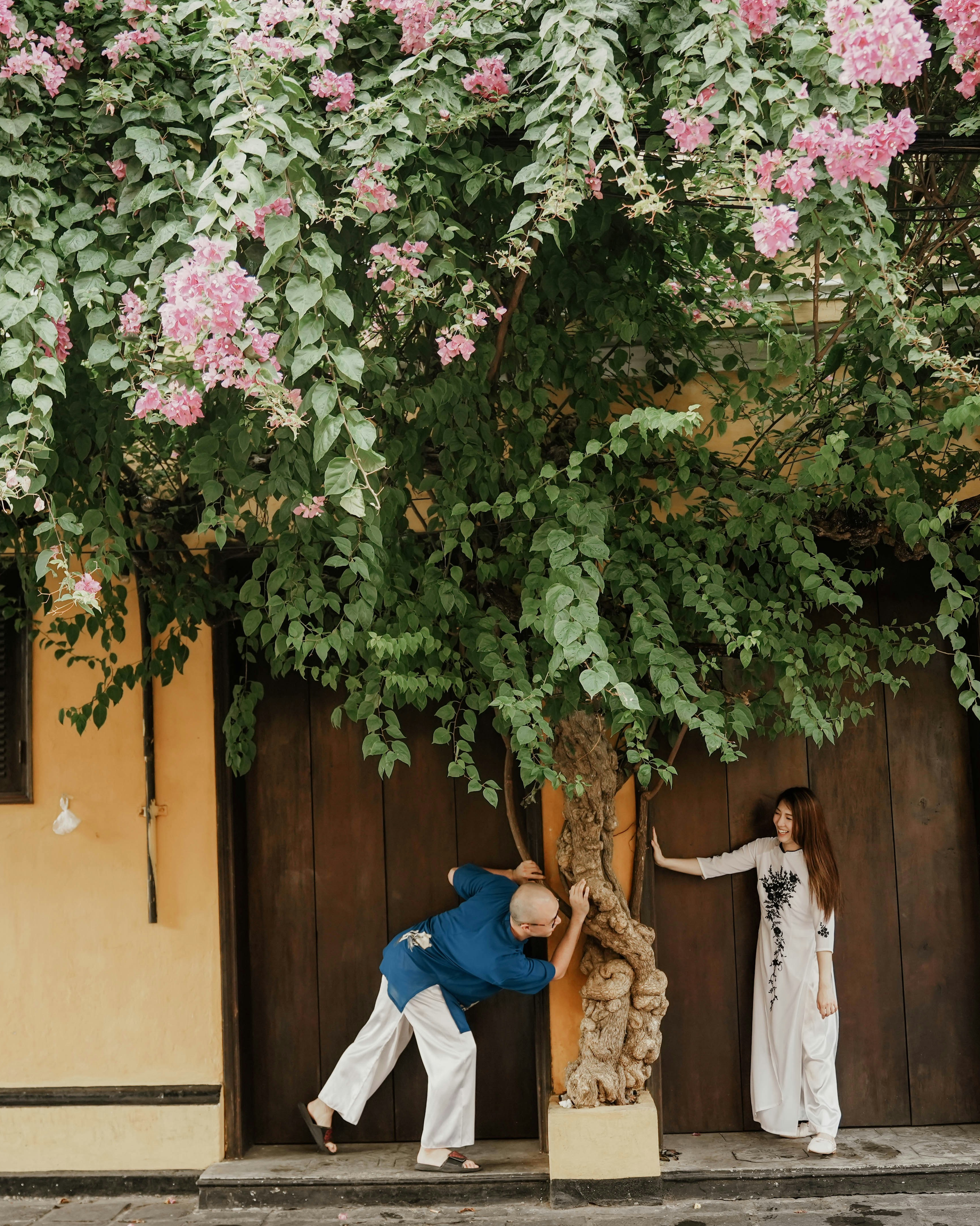 Couple Playing By Flowering Tree