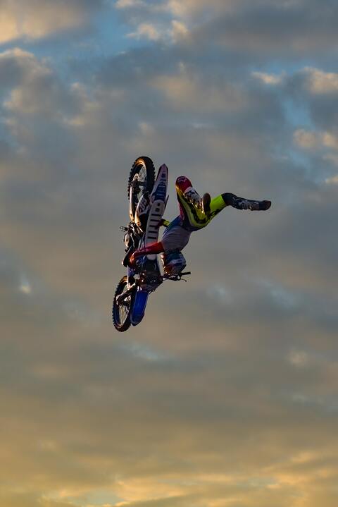 Motocross Rider Aerial Stunt At Sunset